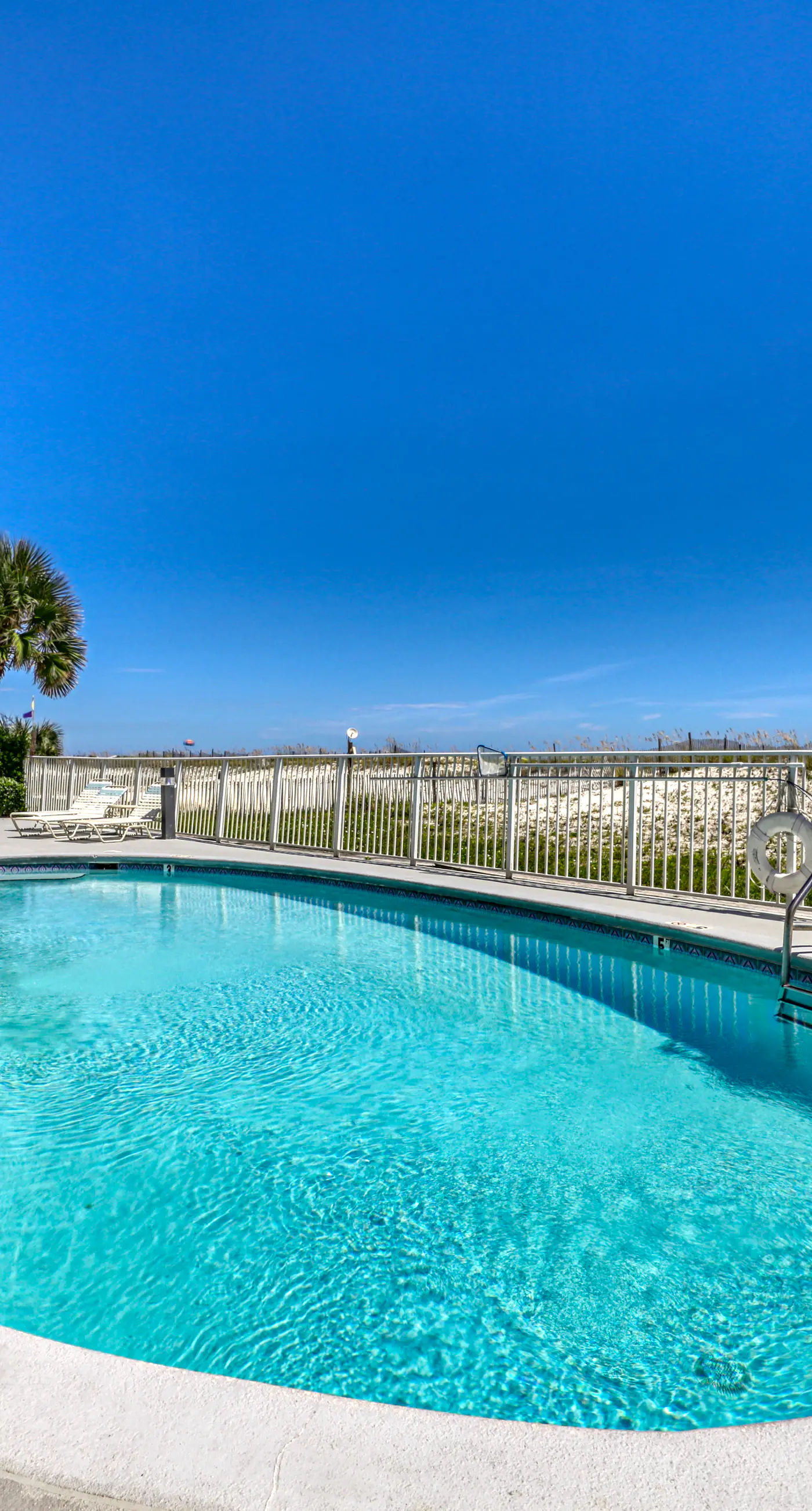 Beachfront, corner condo w a furnished balcony, shared pool, & grilling area