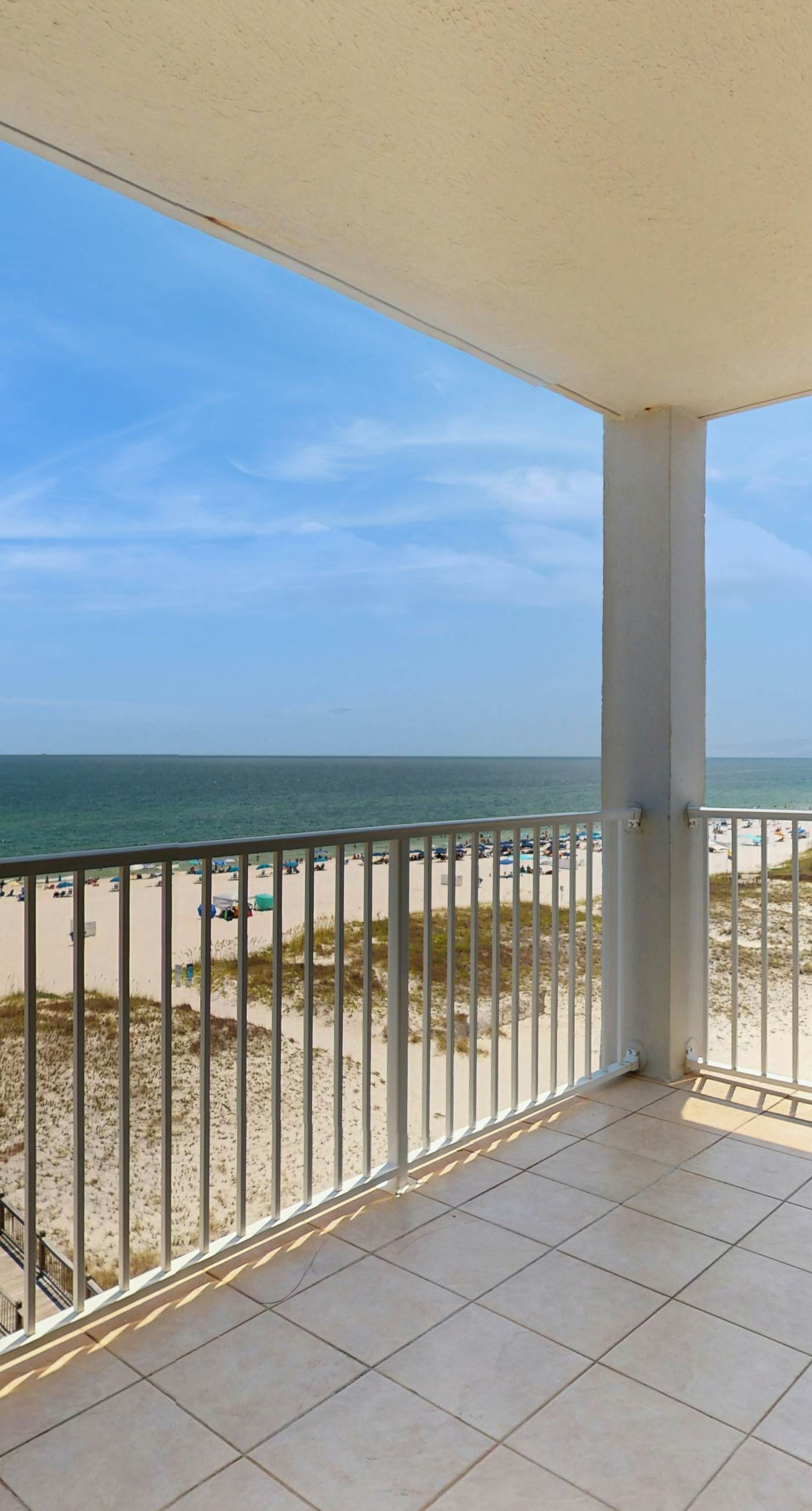 Beachfront, corner condo w a furnished balcony, shared pool, & grilling area