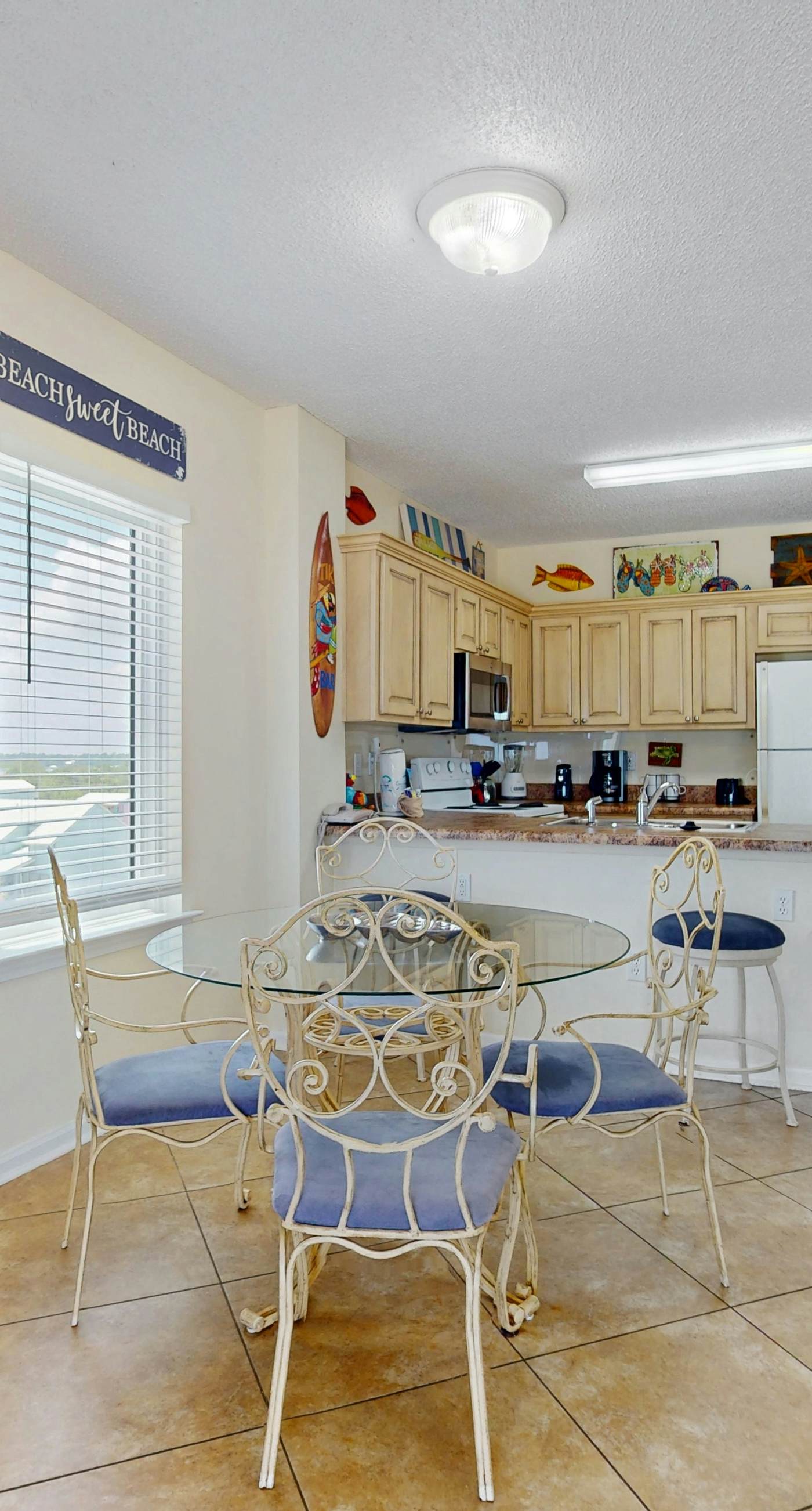 Beachfront, corner condo w a furnished balcony, shared pool, & grilling area