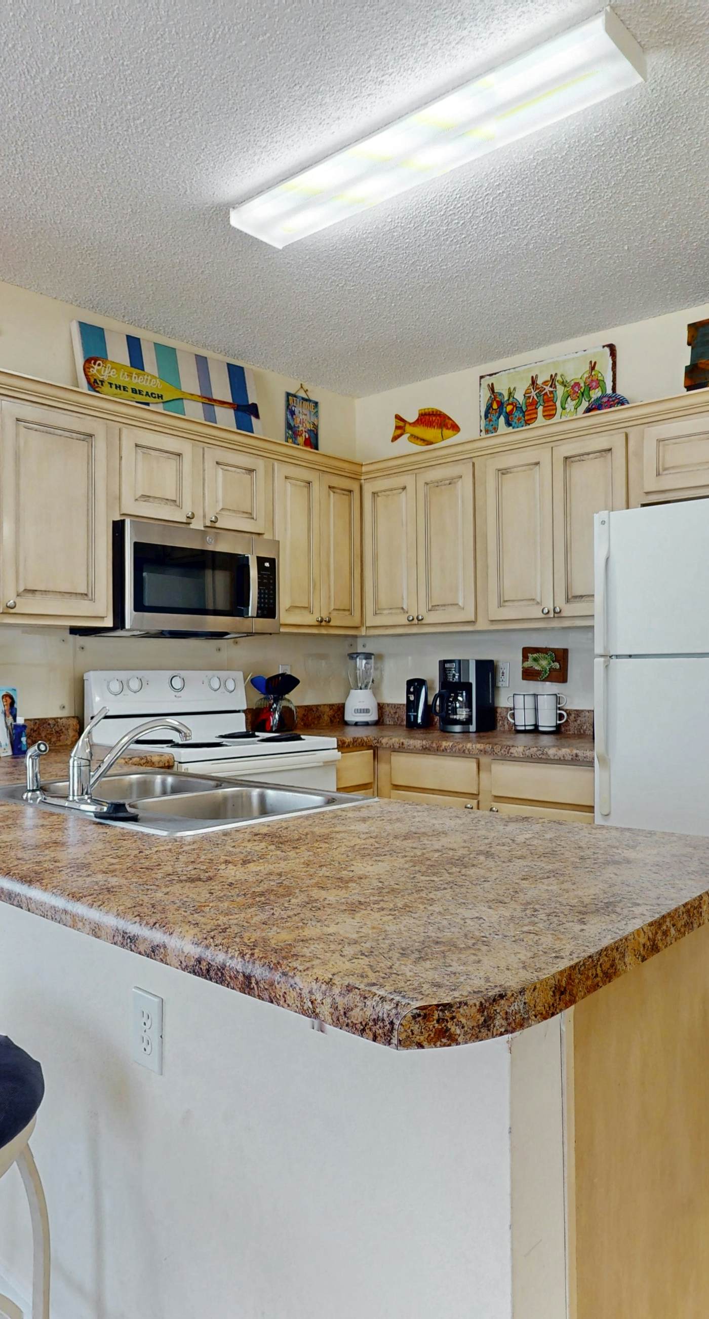 Beachfront, corner condo w a furnished balcony, shared pool, & grilling area