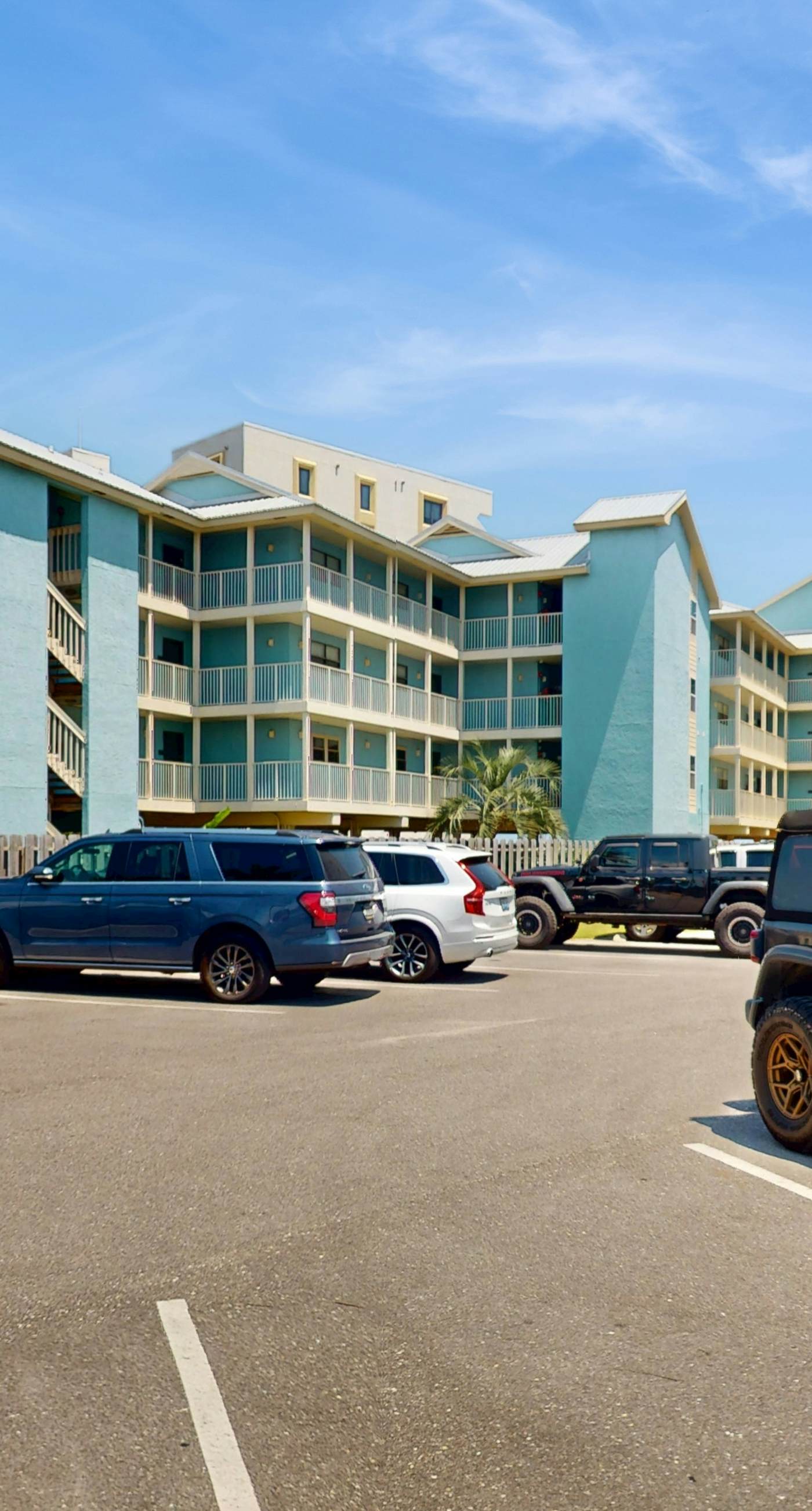 Beachfront, corner condo w a furnished balcony, shared pool, & grilling area