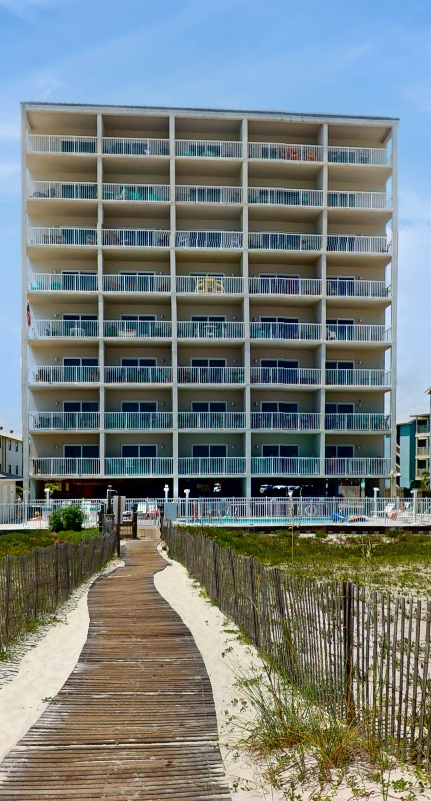 Beachfront, corner condo w a furnished balcony, shared pool, & grilling area
