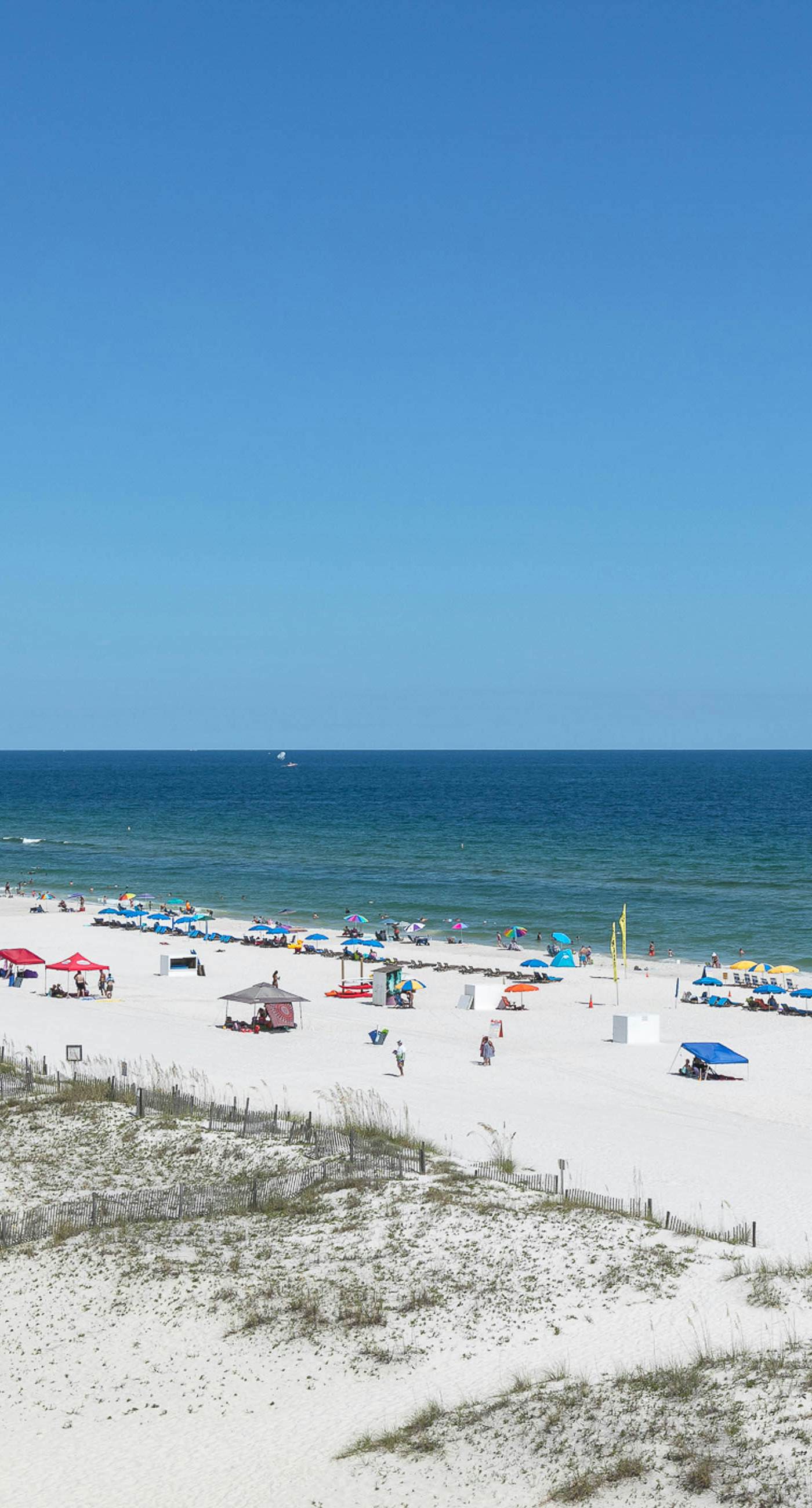 Beachfront, corner condo w a furnished balcony, shared pool, & grilling area