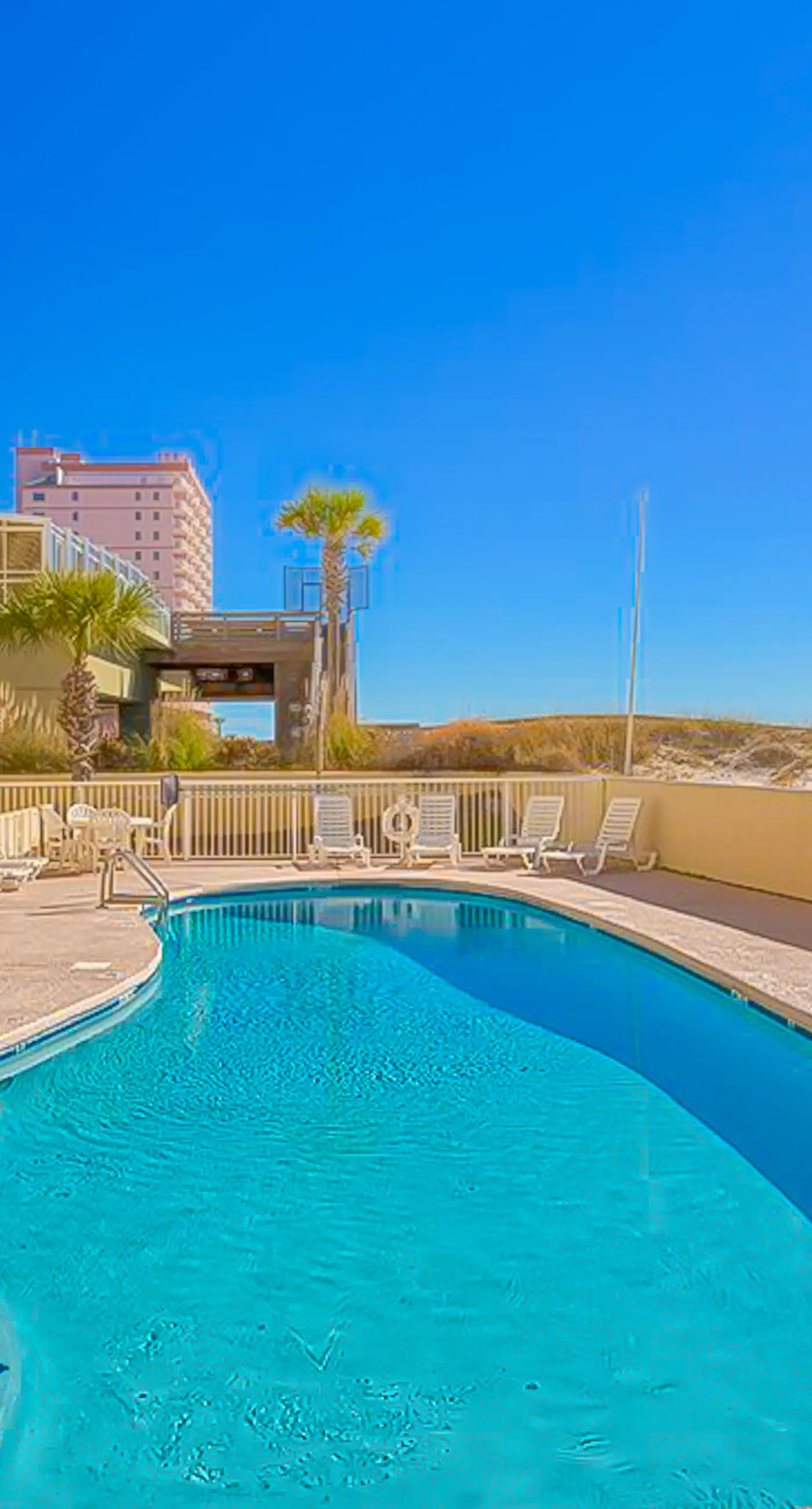Gulf-front 3rd-floor condo with outdoor pool, central AC, & balcony