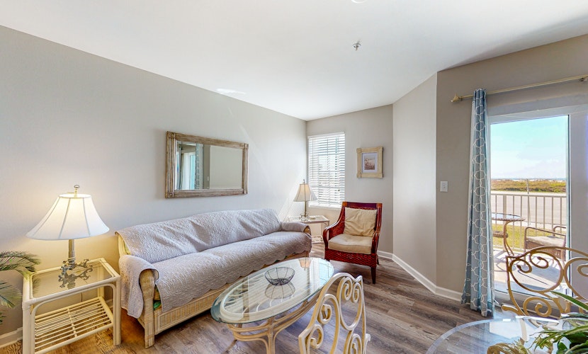 Convenient condo w/ private balcony, beach views, shared pool & AC