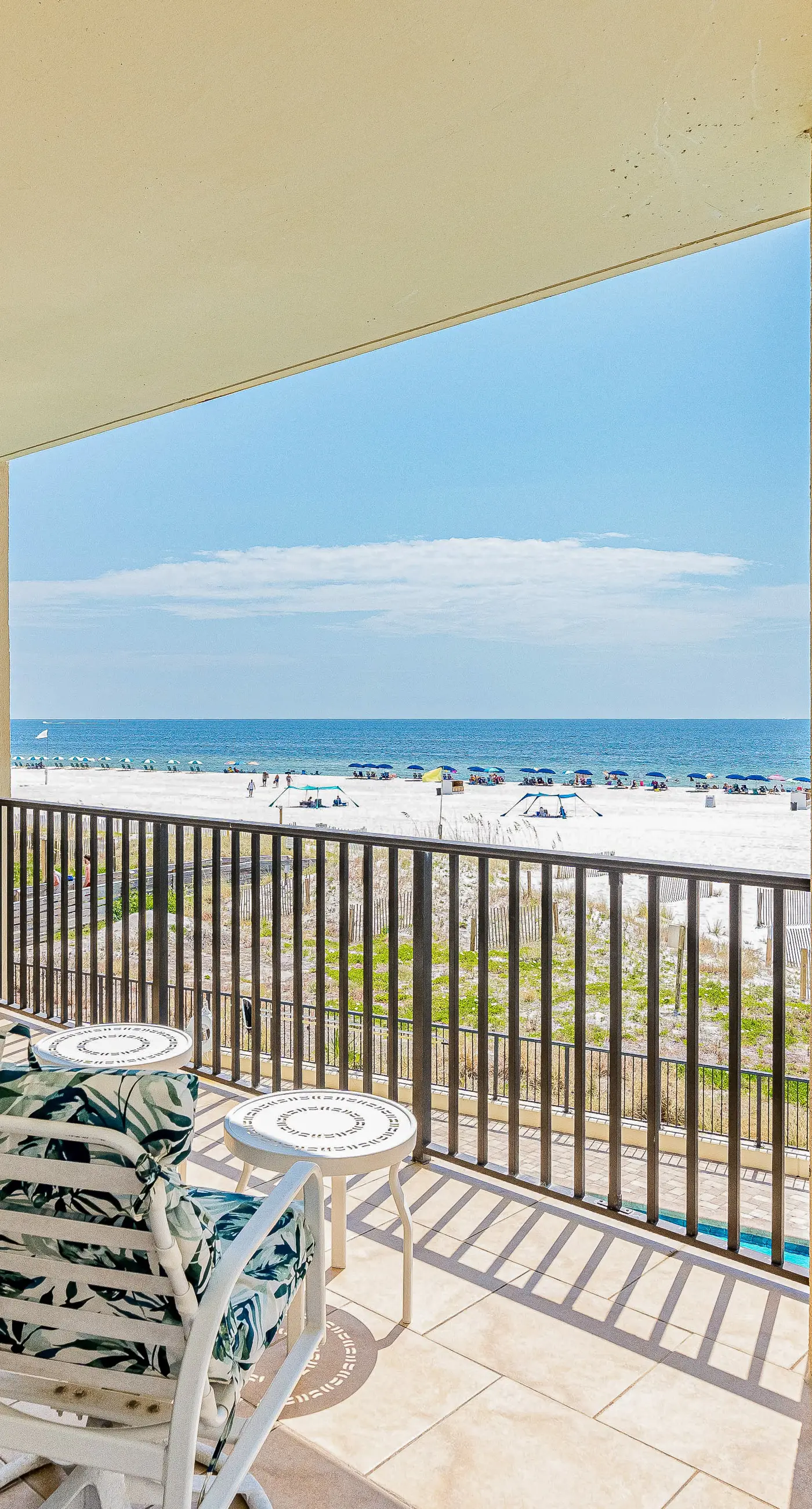 Gulf-front condo with spacious balcony, resort amenities, and cheerful interior