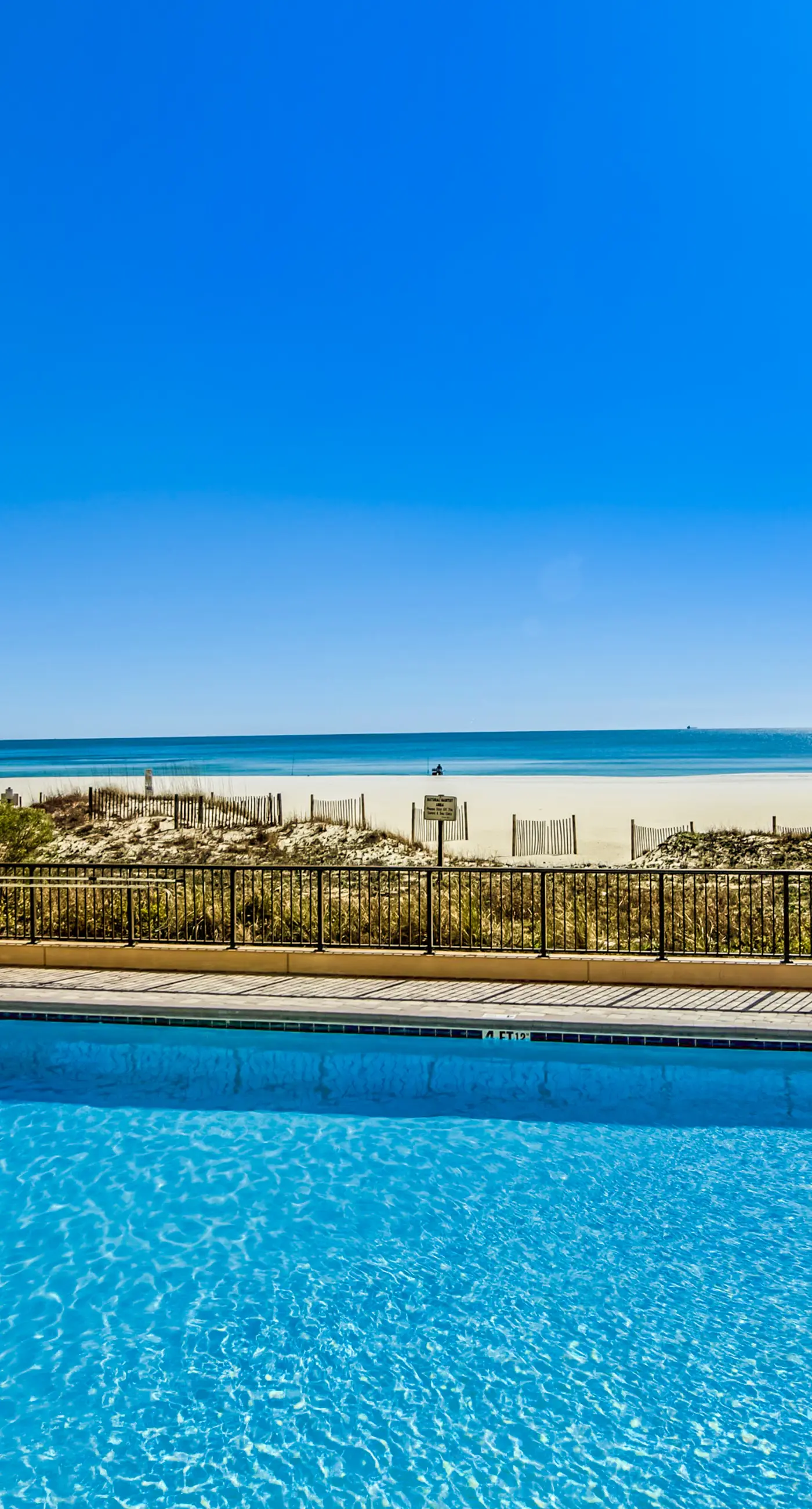 Gulf-front condo with spacious balcony, resort amenities, and cheerful interior