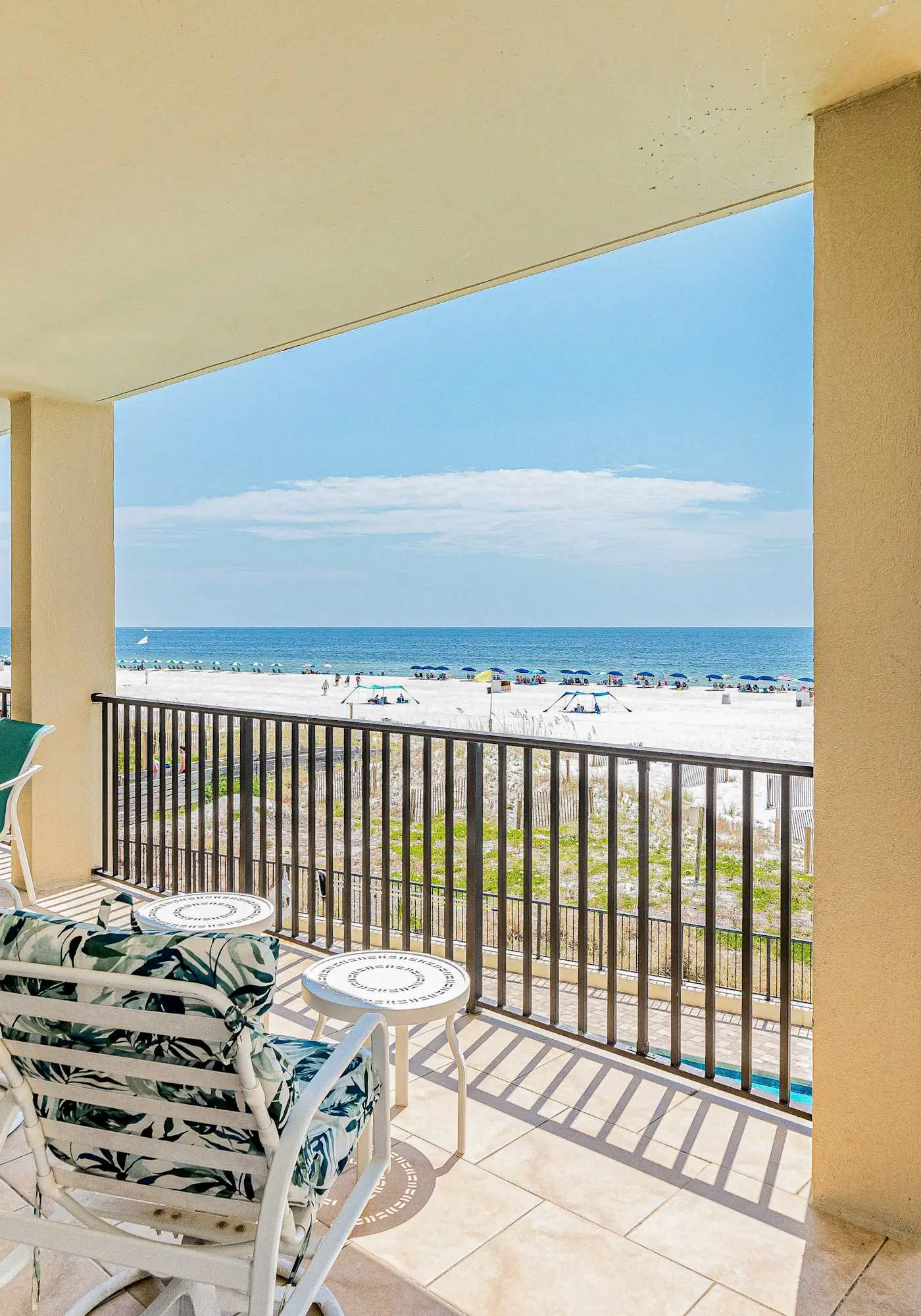 Gulf-front condo with spacious balcony, resort amenities, and cheerful interior