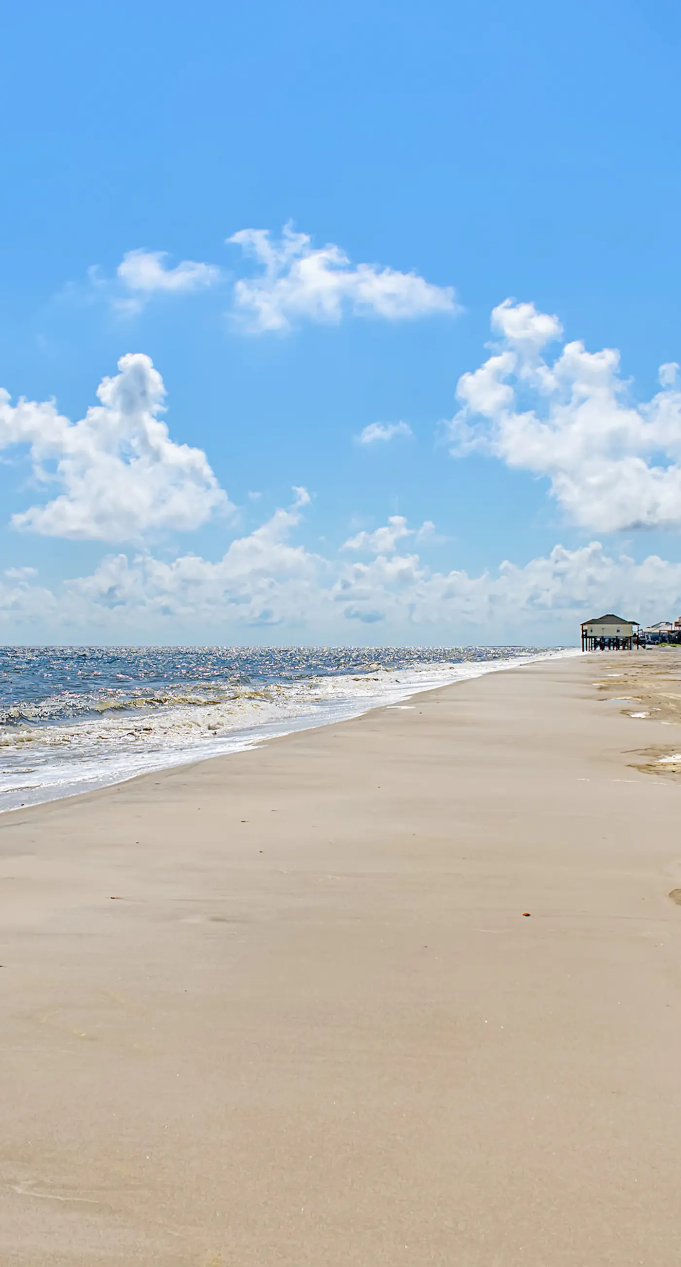 Family-friendly, beachfront getaway with a stainless kitchen & shared pool