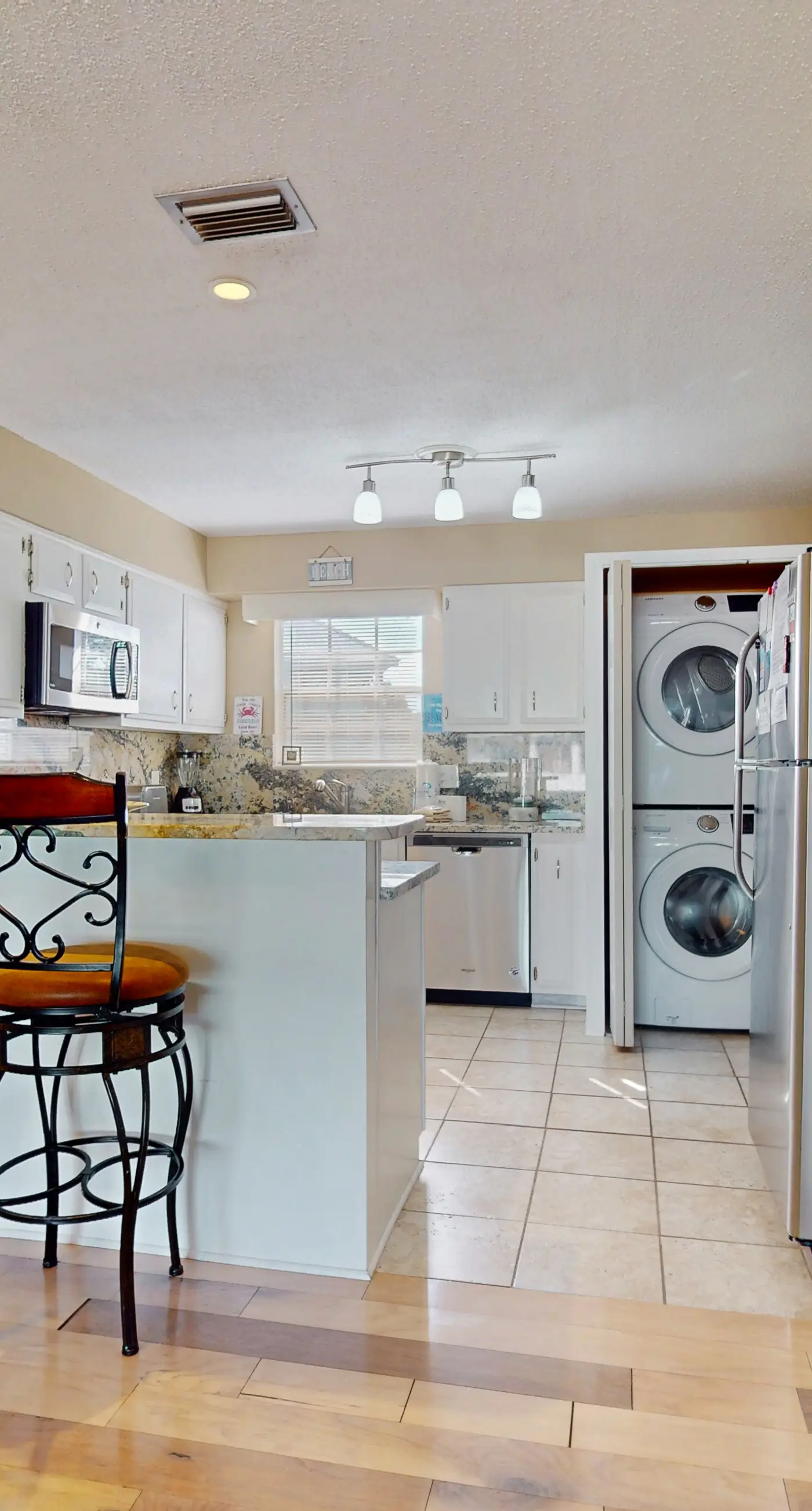 Family-friendly, beachfront getaway with a stainless kitchen & shared pool