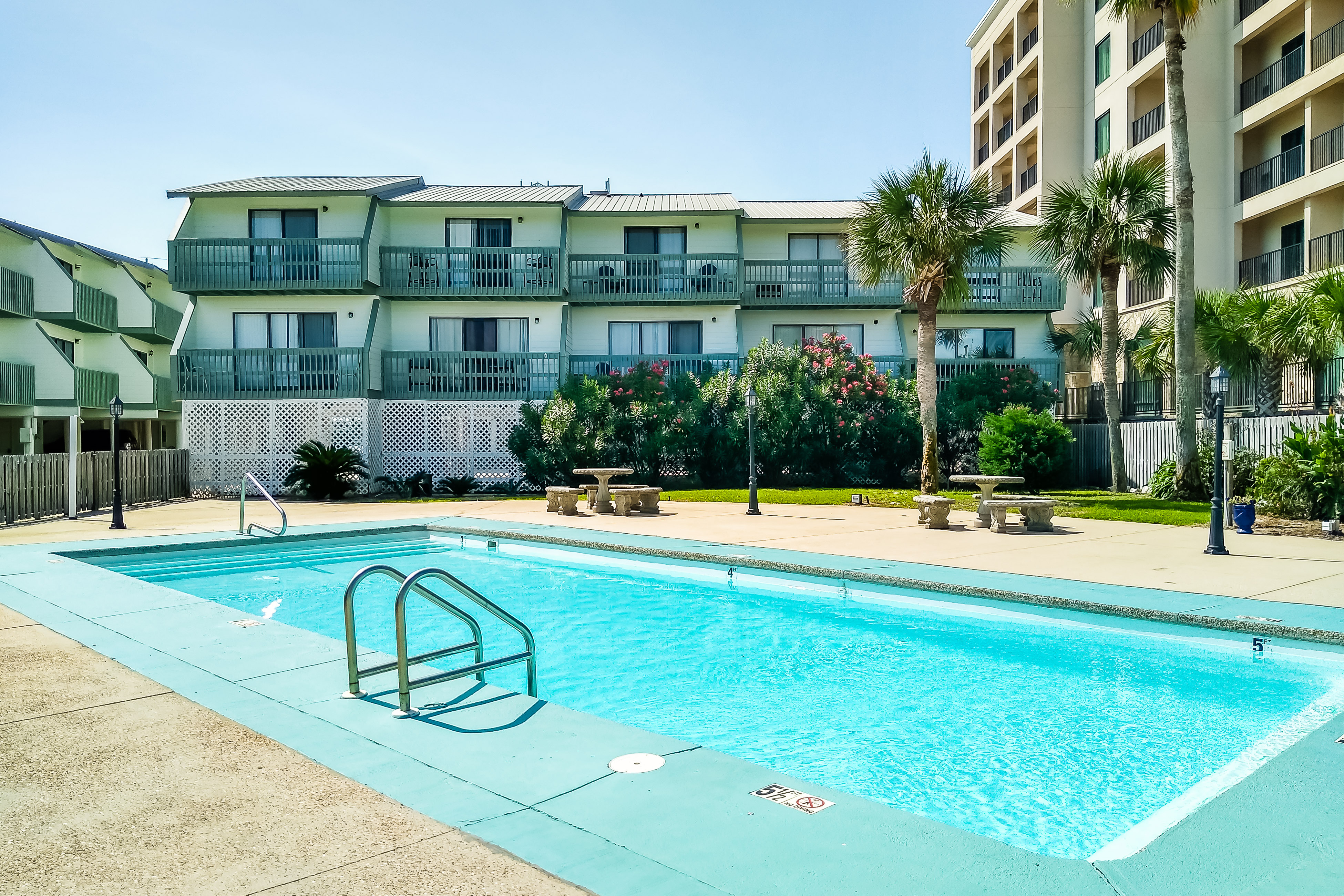 Renovated condo by the beach with pool access & private balconies