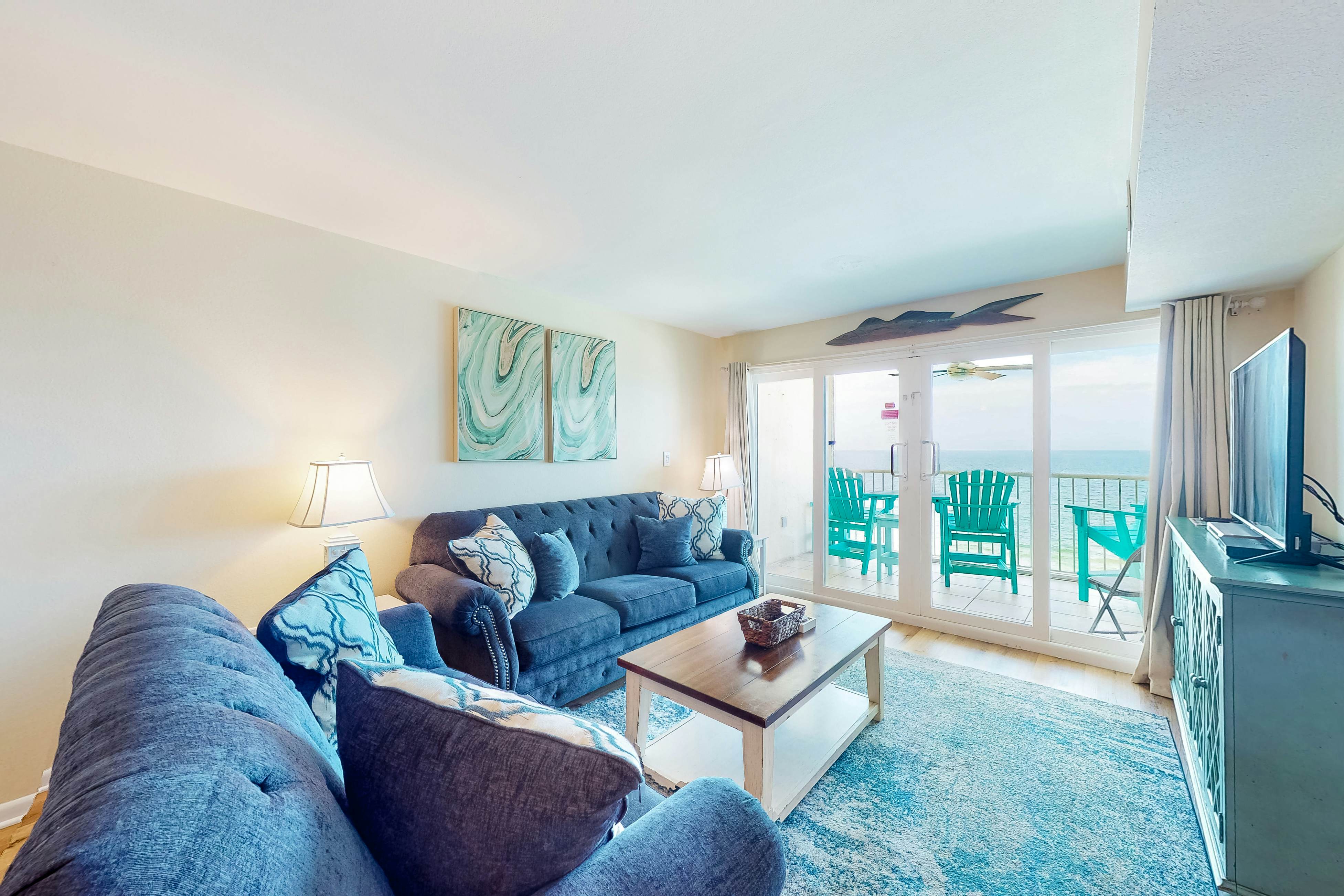 Inviting condo with ocean view, on-site pool, cozy balcony, washer/dryer & AC