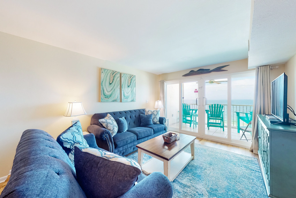 Inviting condo with ocean view, on-site pool, cozy balcony, washer/dryer & AC