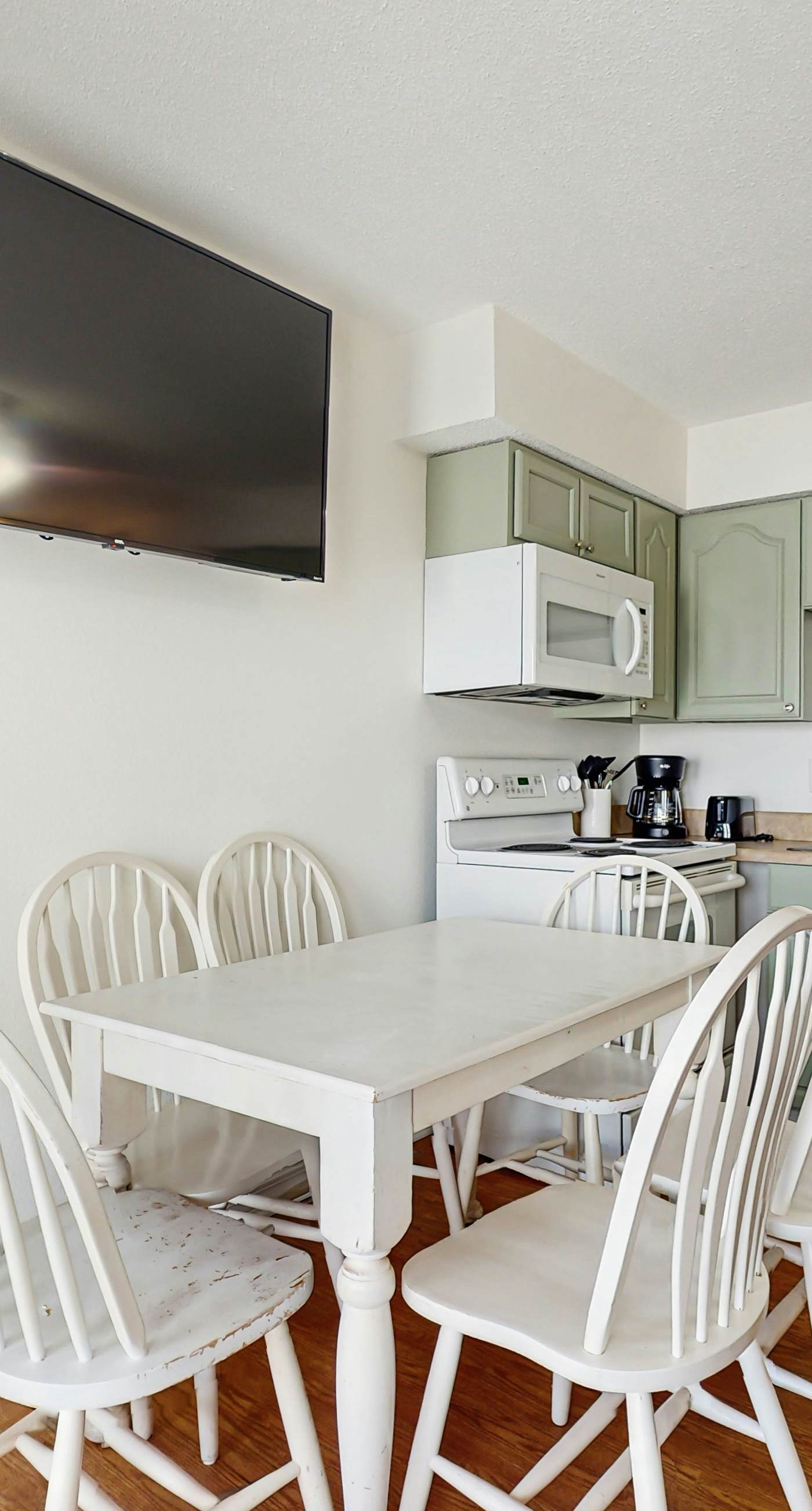 Bright condo near beach with pool access, balcony, & central AC