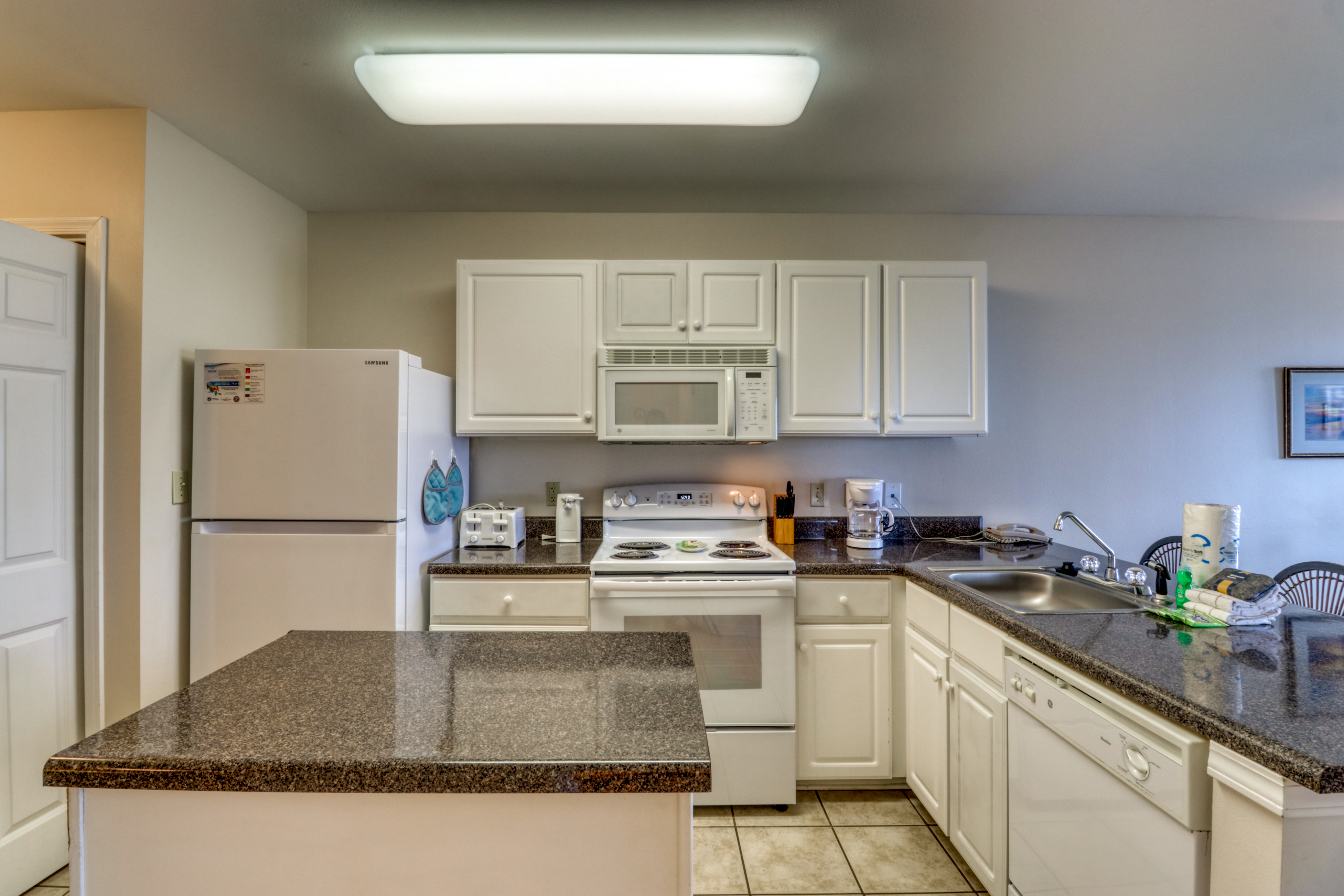 Second floor condo with Gulf view, shared pool, central AC, & BBQ area