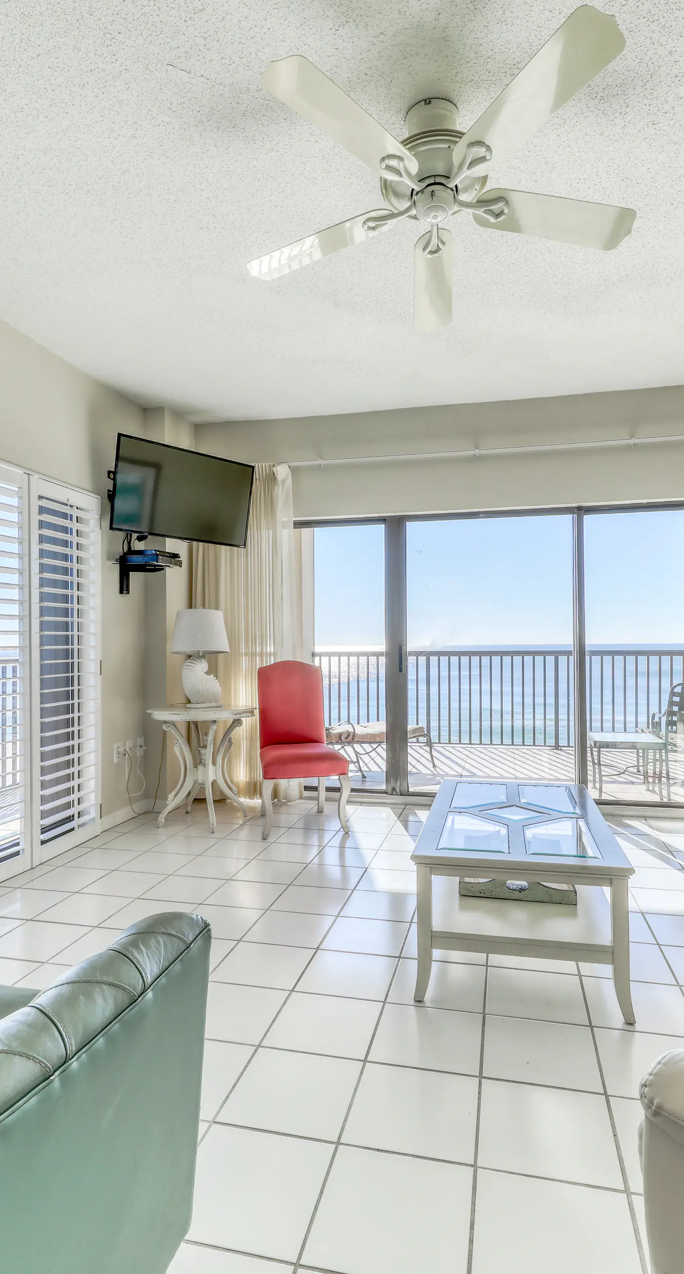 Waterfront corner condo with shared pools, wrap-around balcony, & tennis courts