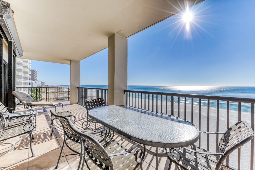 Waterfront corner condo with shared pools, wrap-around balcony, & tennis courts