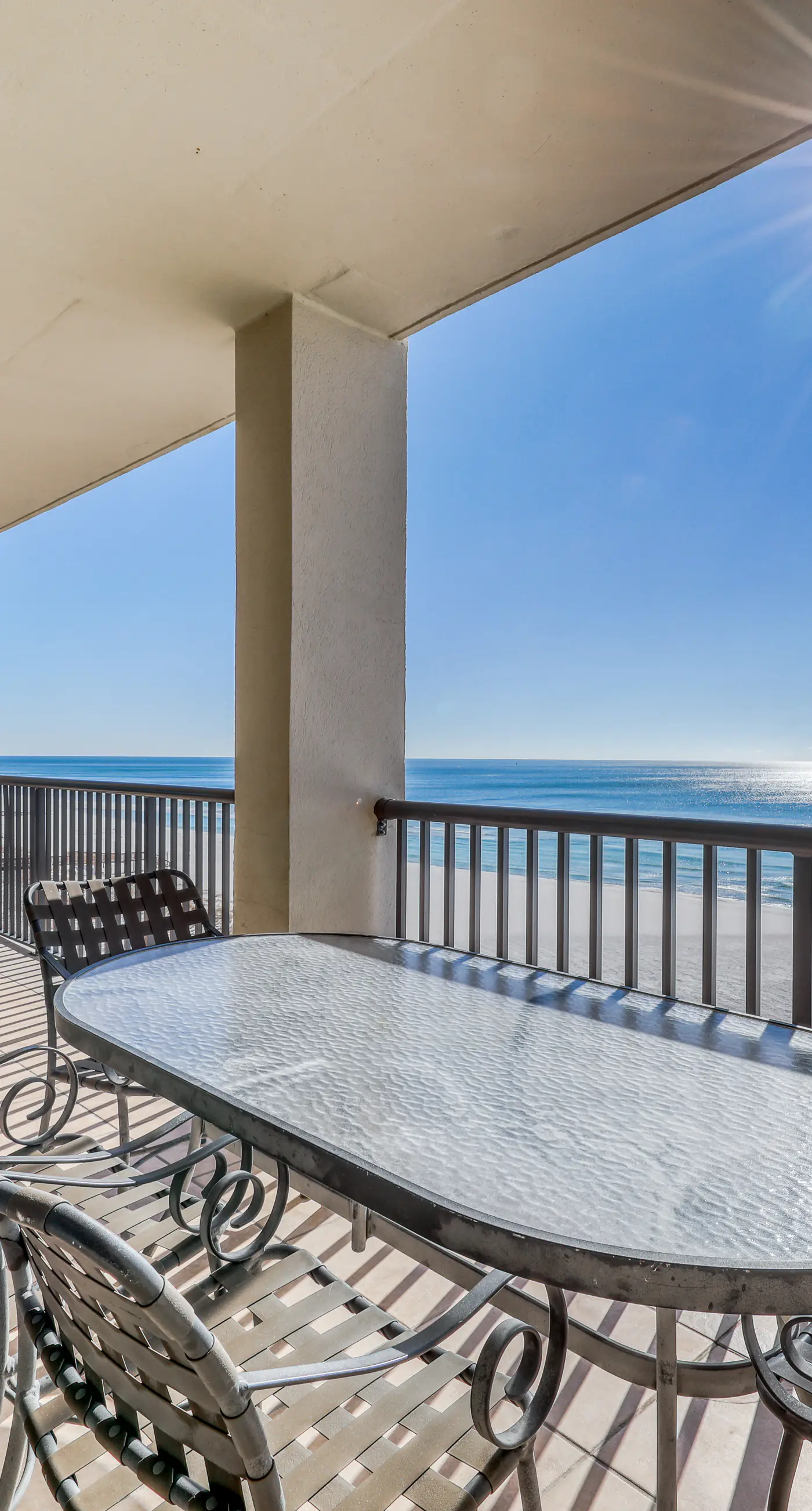 Waterfront corner condo with shared pools, wrap-around balcony, & tennis courts