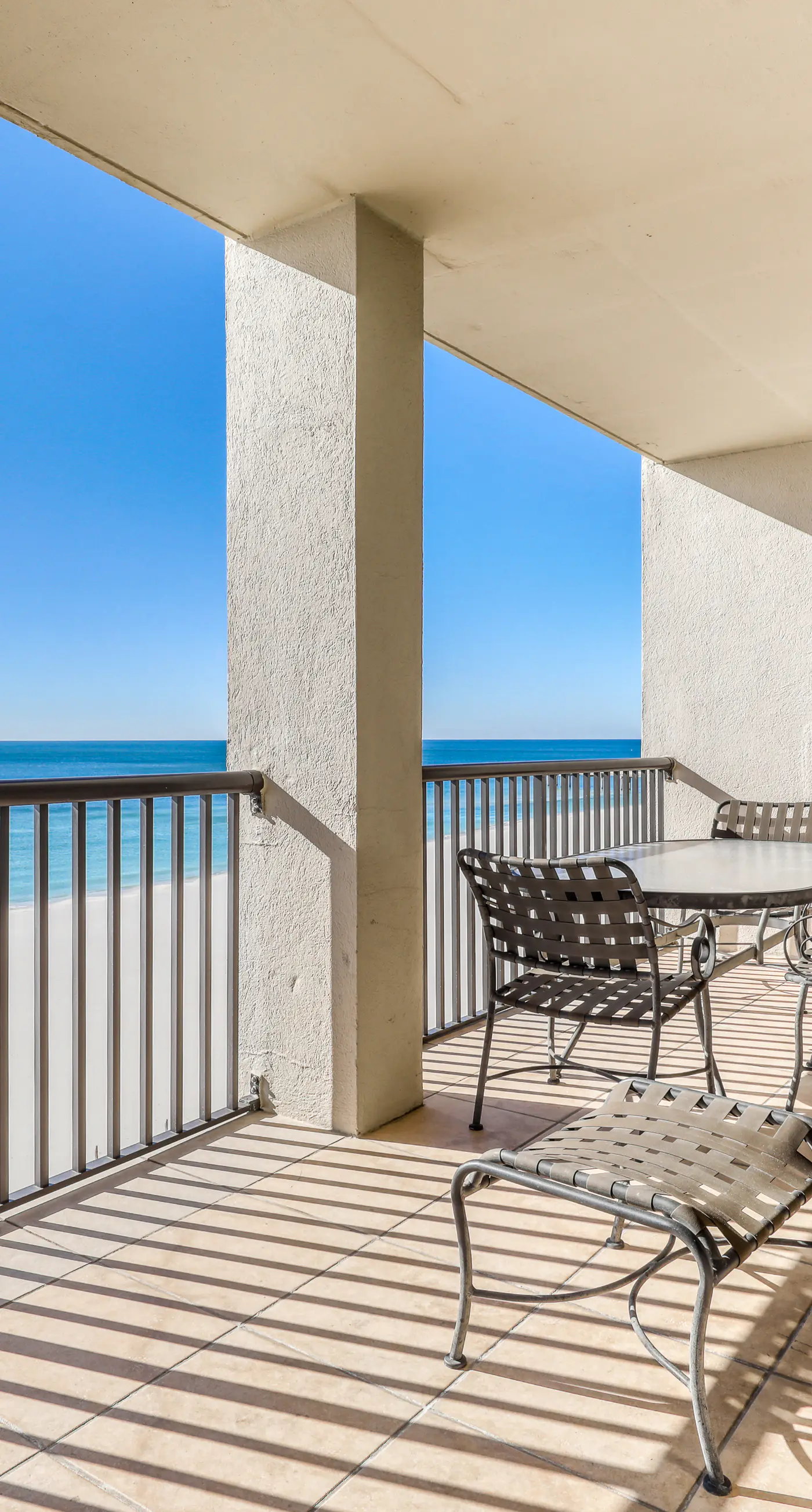 Waterfront corner condo with shared pools, wrap-around balcony, & tennis courts
