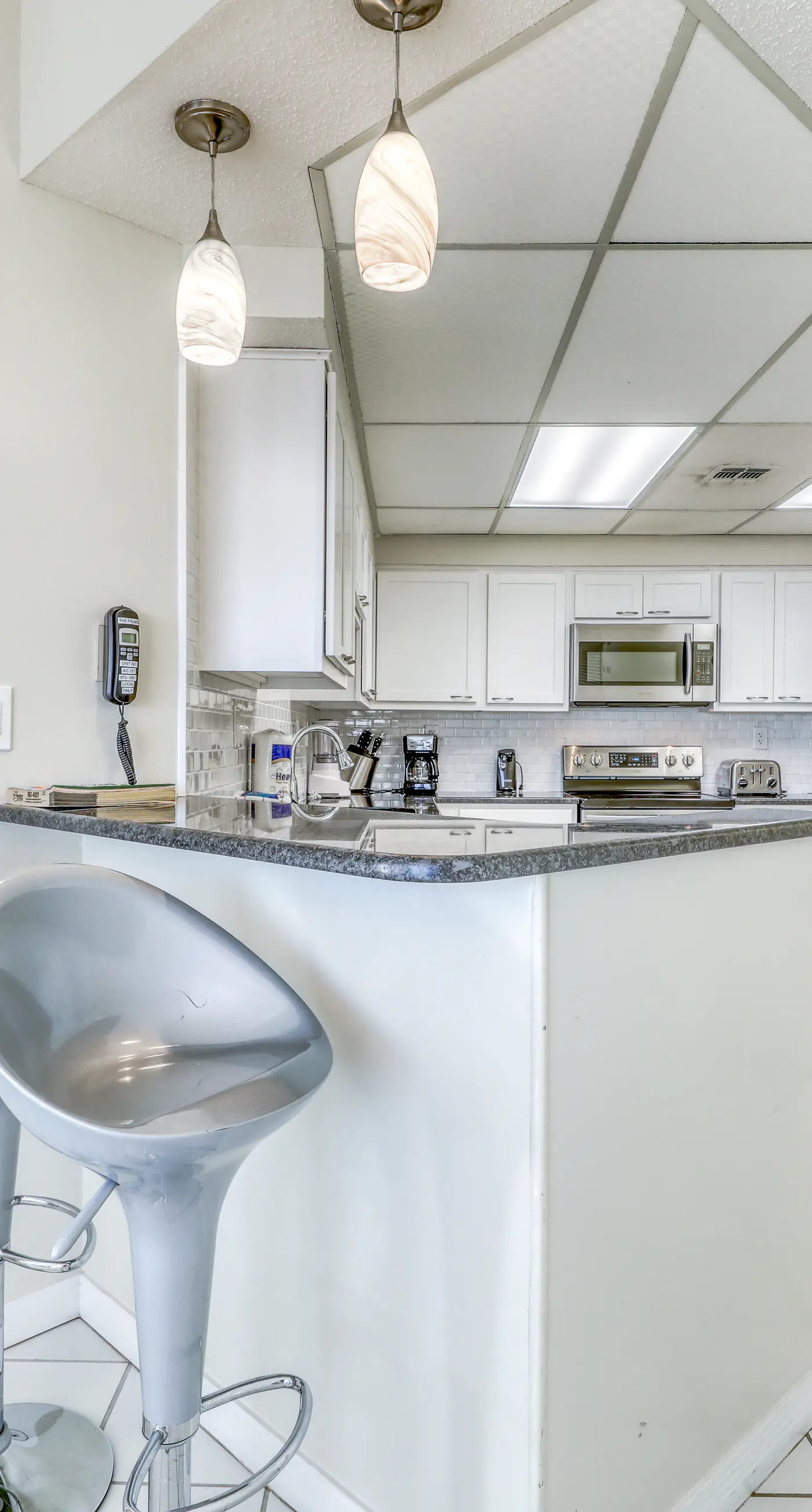 Waterfront corner condo with shared pools, wrap-around balcony, & tennis courts