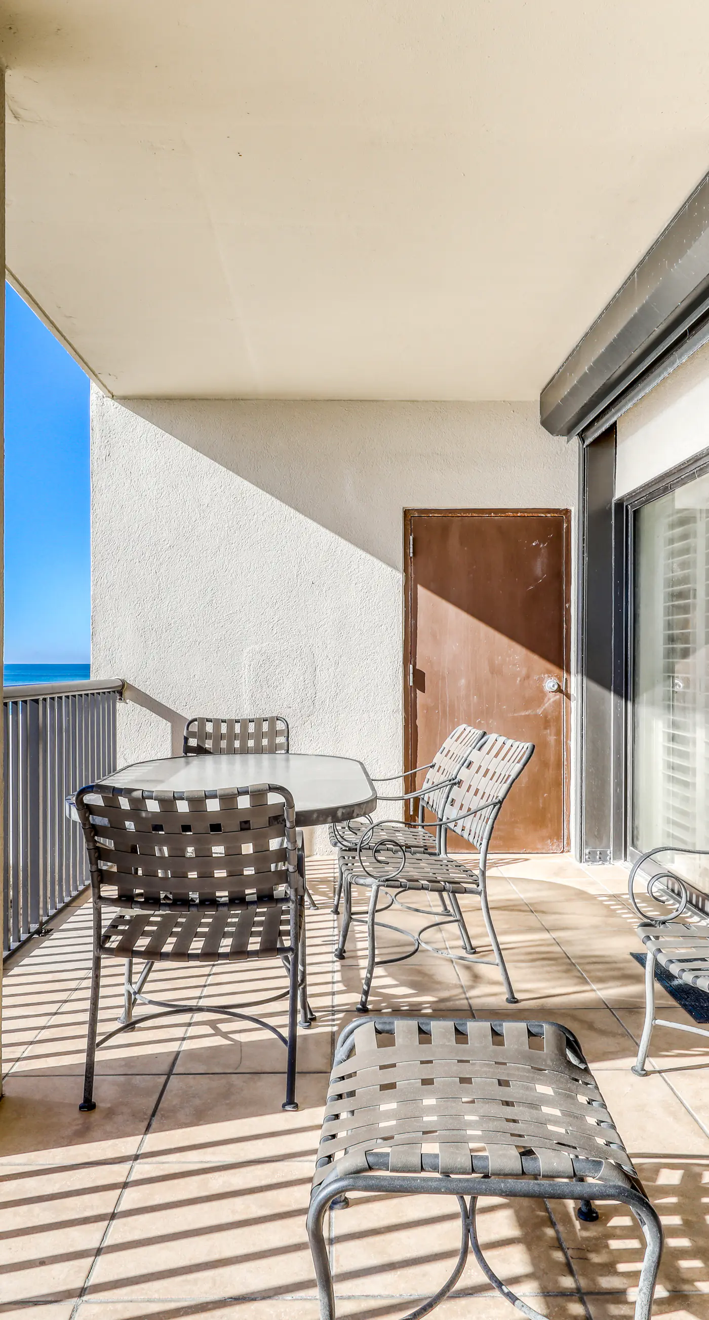 Waterfront corner condo with shared pools, wrap-around balcony, & tennis courts