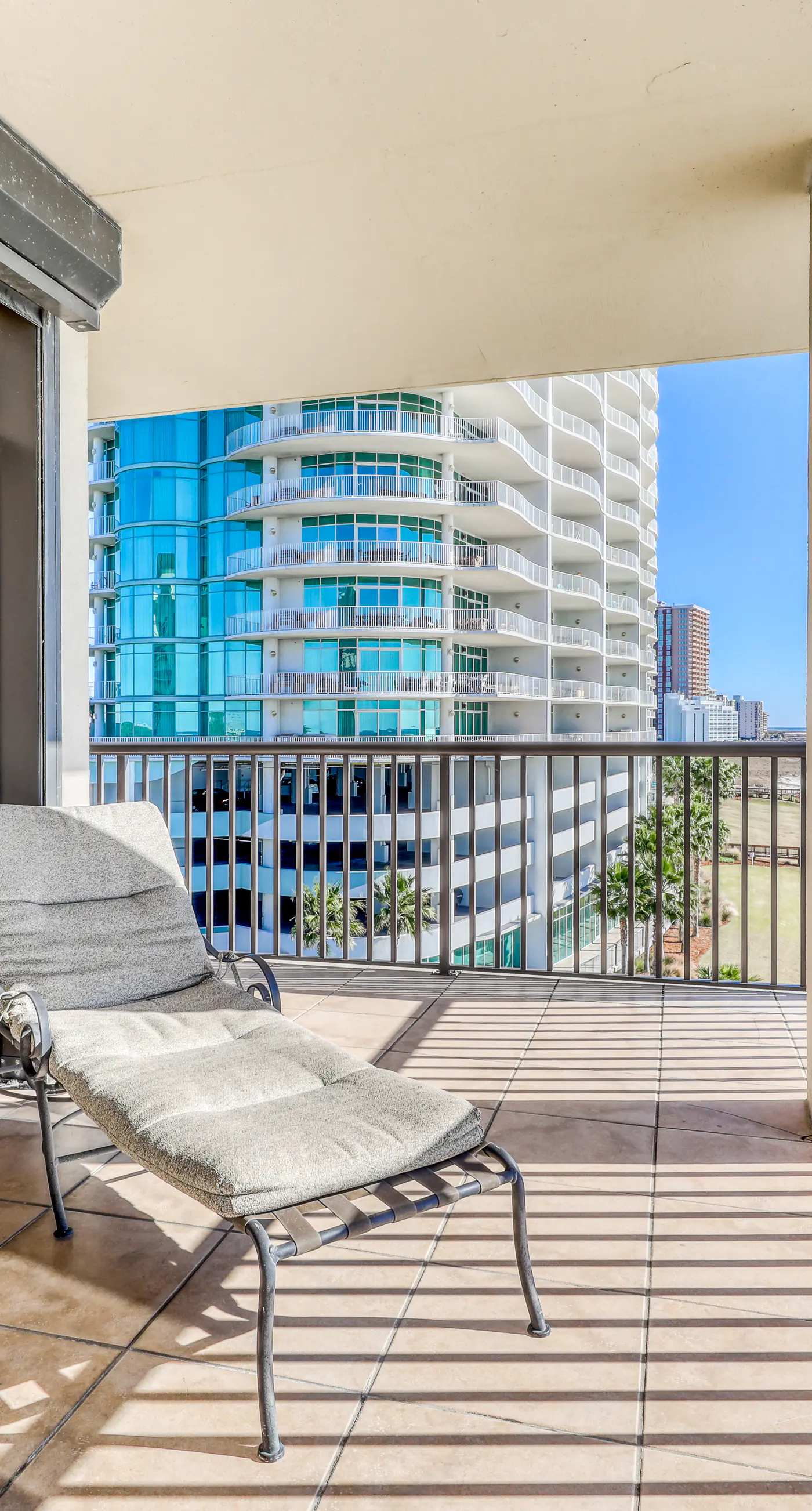 Waterfront corner condo with shared pools, wrap-around balcony, & tennis courts