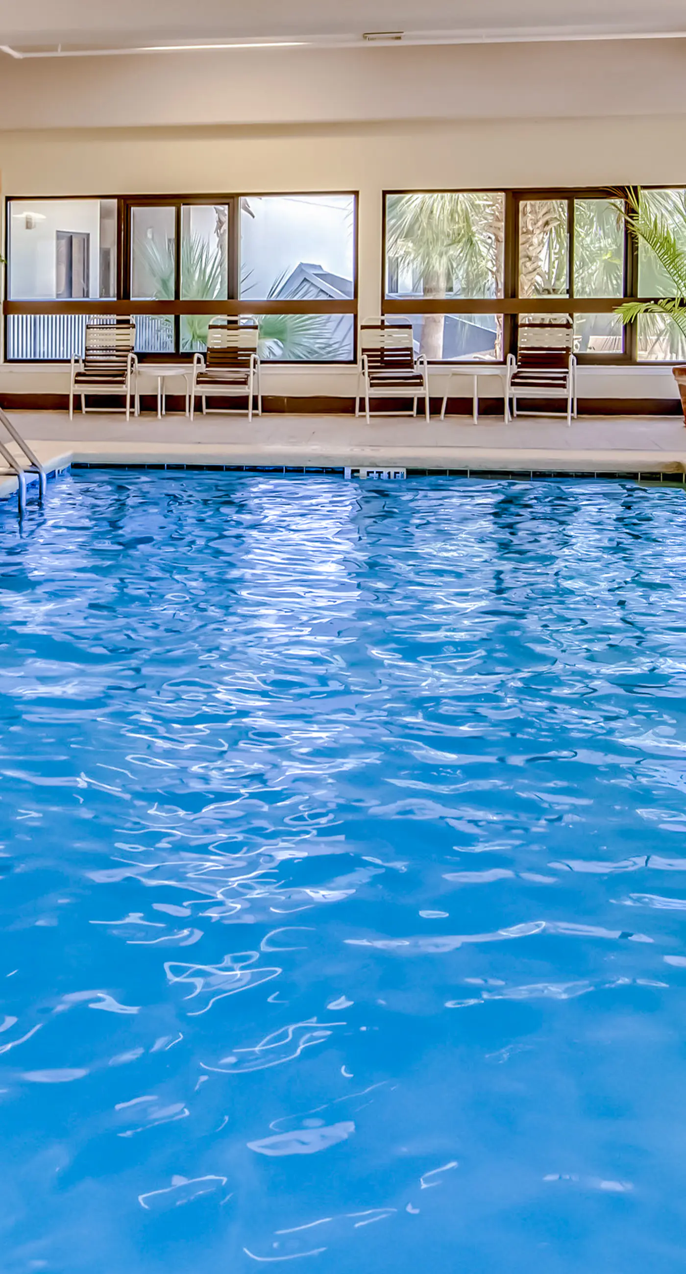 Waterfront corner condo with shared pools, wrap-around balcony, & tennis courts