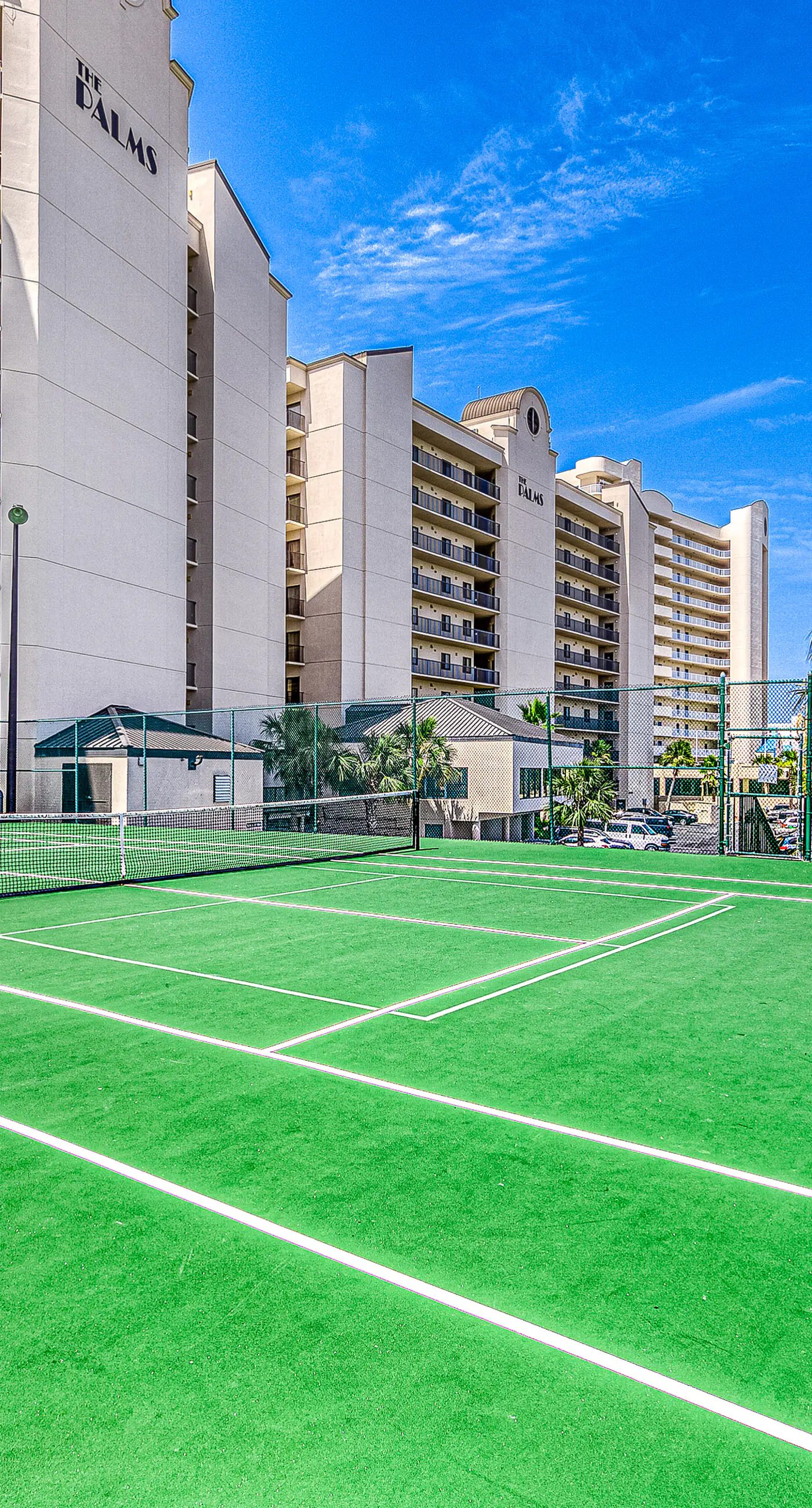 Waterfront corner condo with shared pools, wrap-around balcony, & tennis courts
