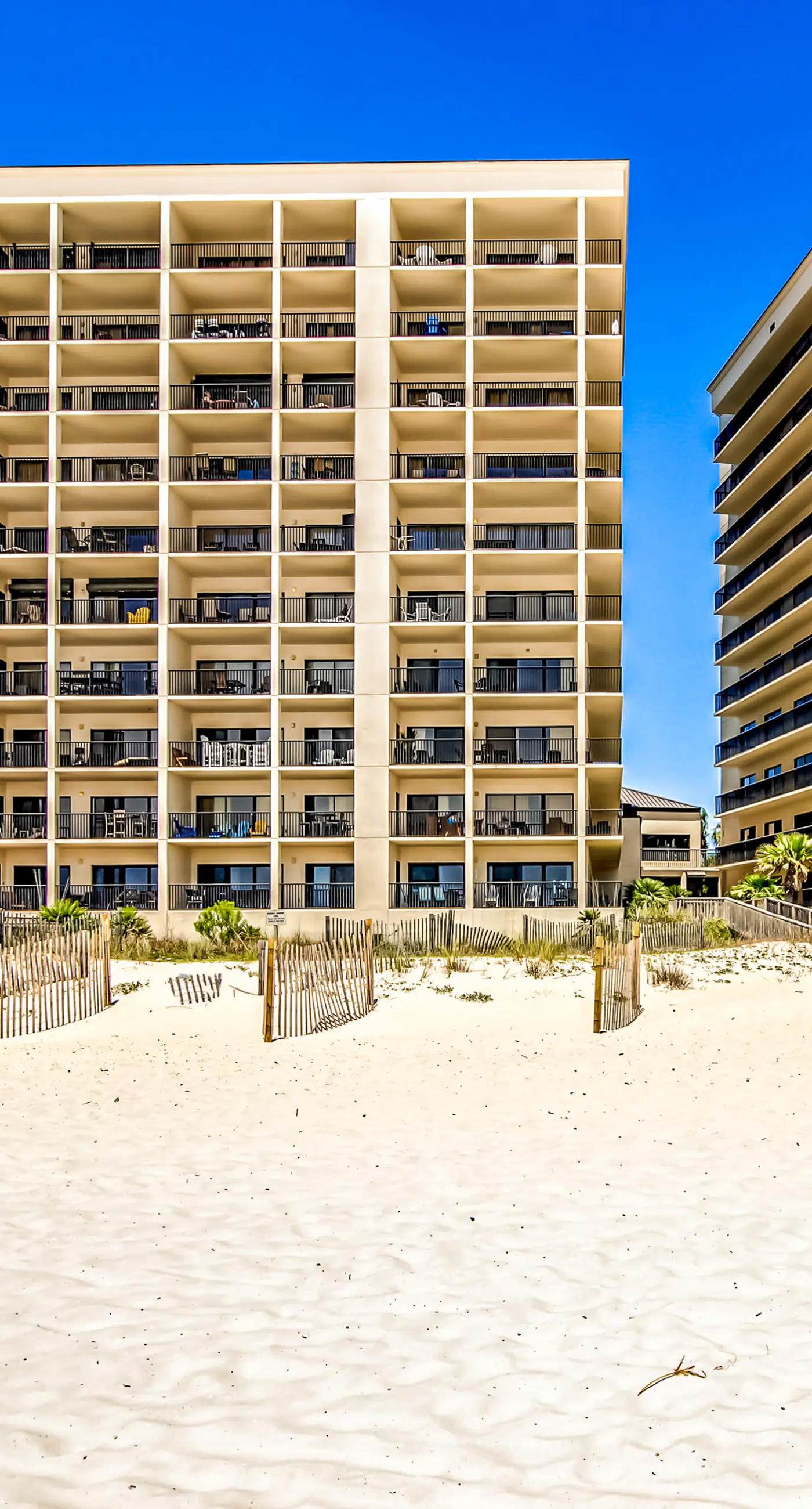 Waterfront corner condo with shared pools, wrap-around balcony, & tennis courts