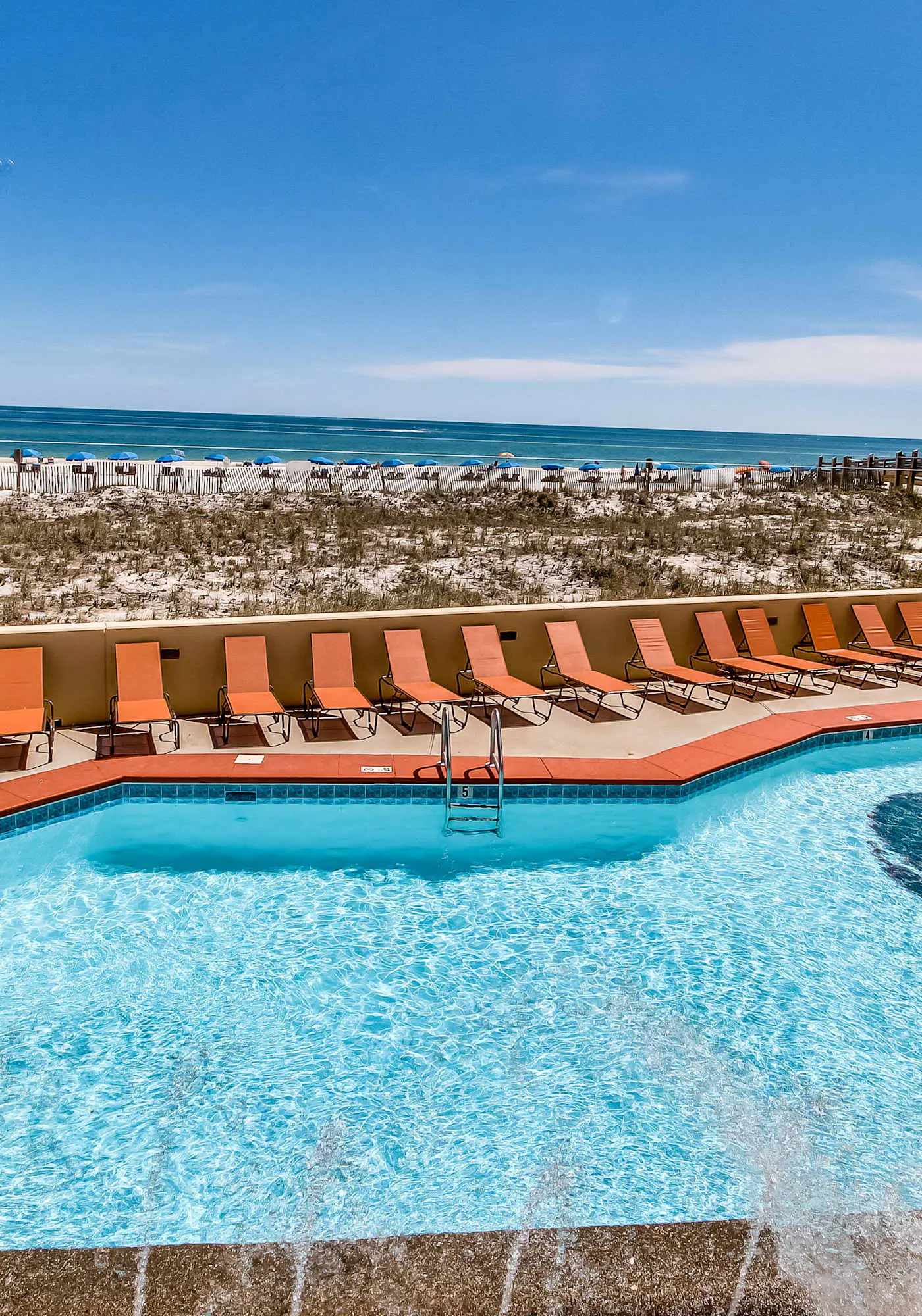 Casual beachfront getaway with pool, ocean views, & beach access
