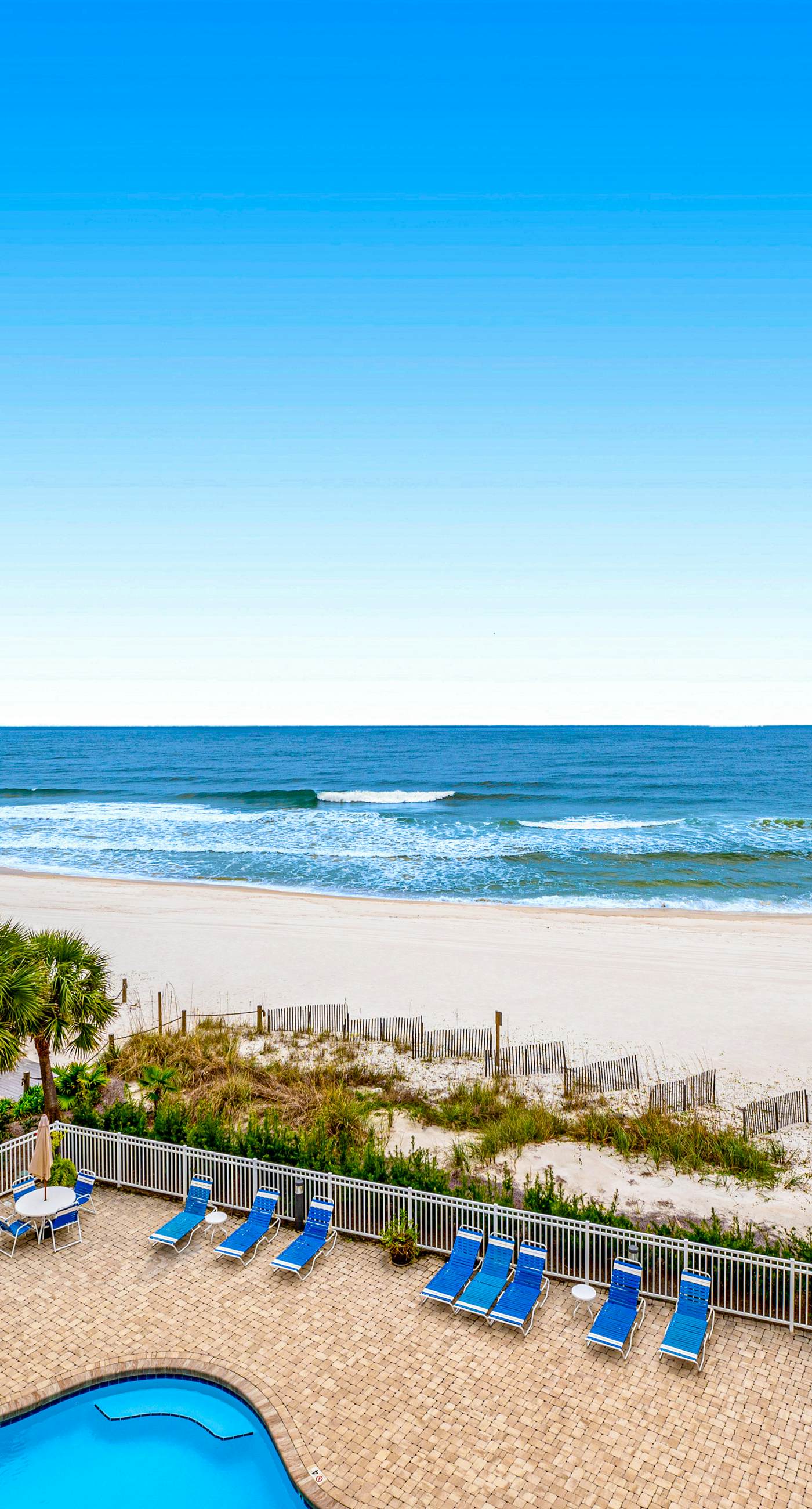 Beachfront condo with Gulf front shared pool, private balcony, and grilling area