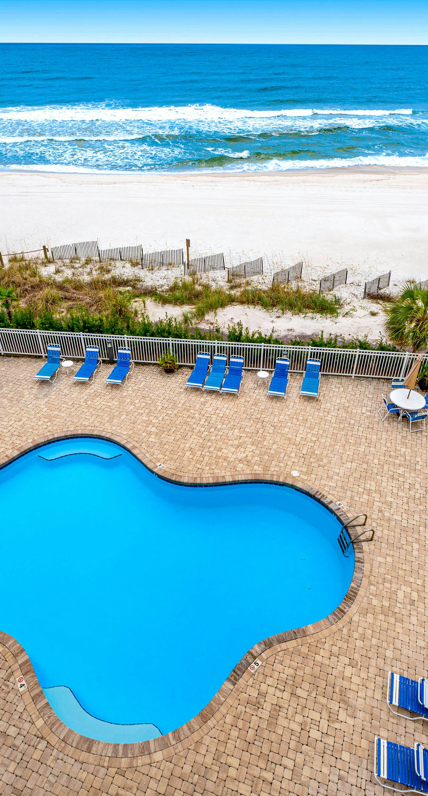 Beachfront condo with Gulf front shared pool, private balcony, and grilling area