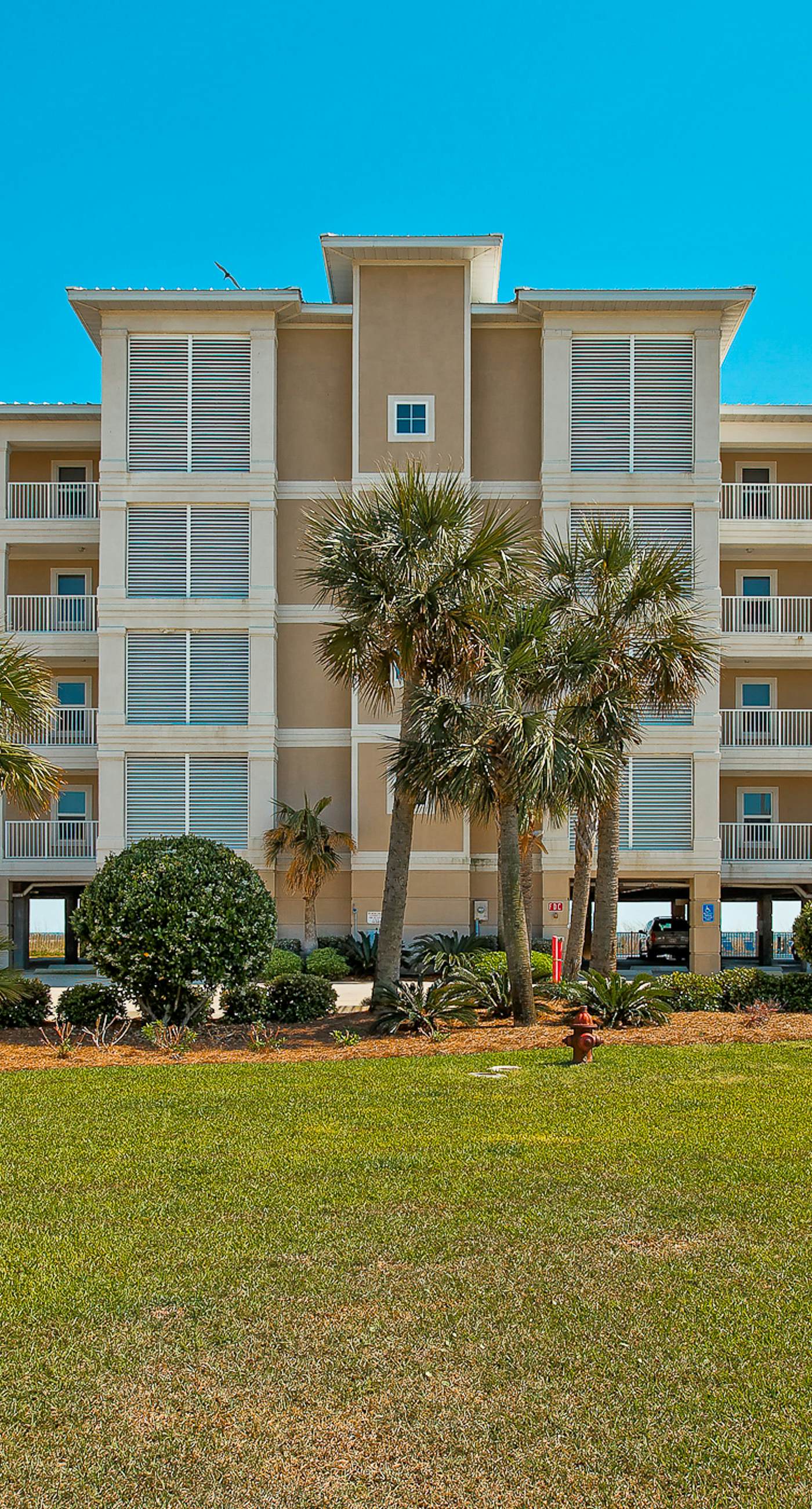 Beachfront condo with Gulf front shared pool, private balcony, and grilling area