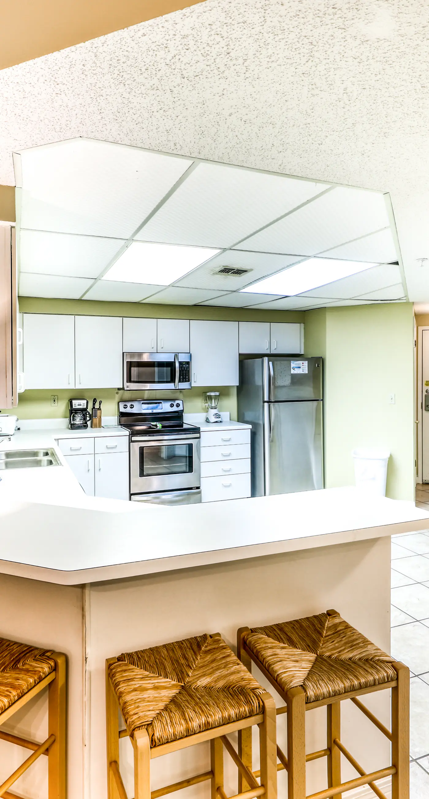 Beachfront condo with shared outdoor pool, heated indoor pool, sauna, & grill area