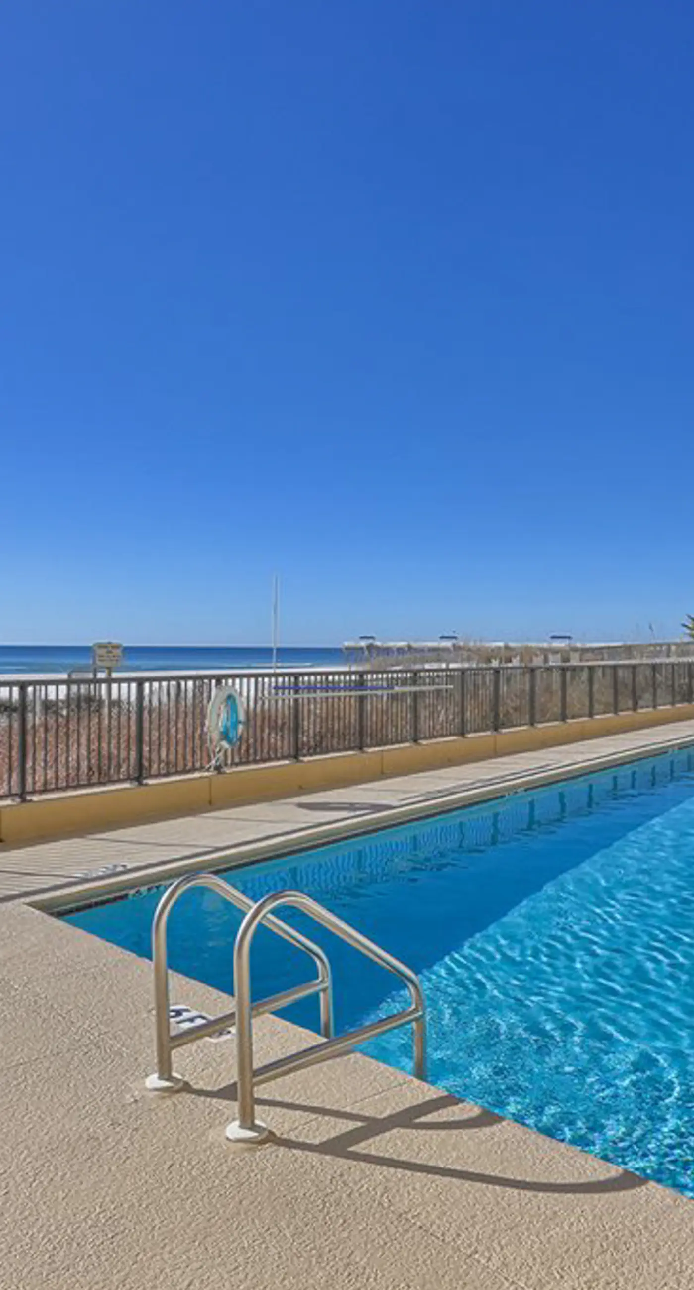 Beachfront condo with shared outdoor pool, heated indoor pool, sauna, & grill area
