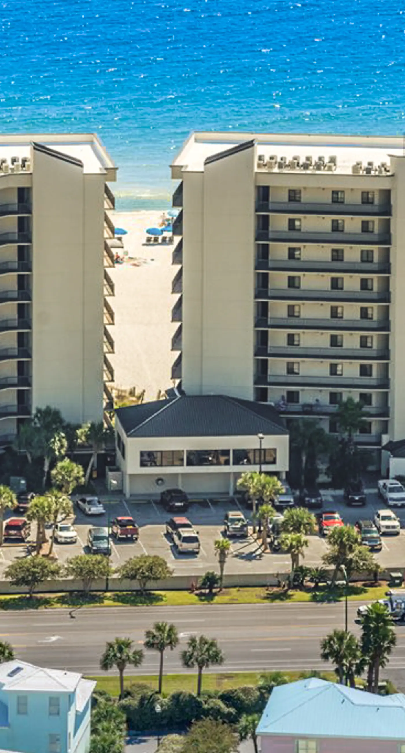 Beachfront condo with shared outdoor pool, heated indoor pool, sauna, & grill area