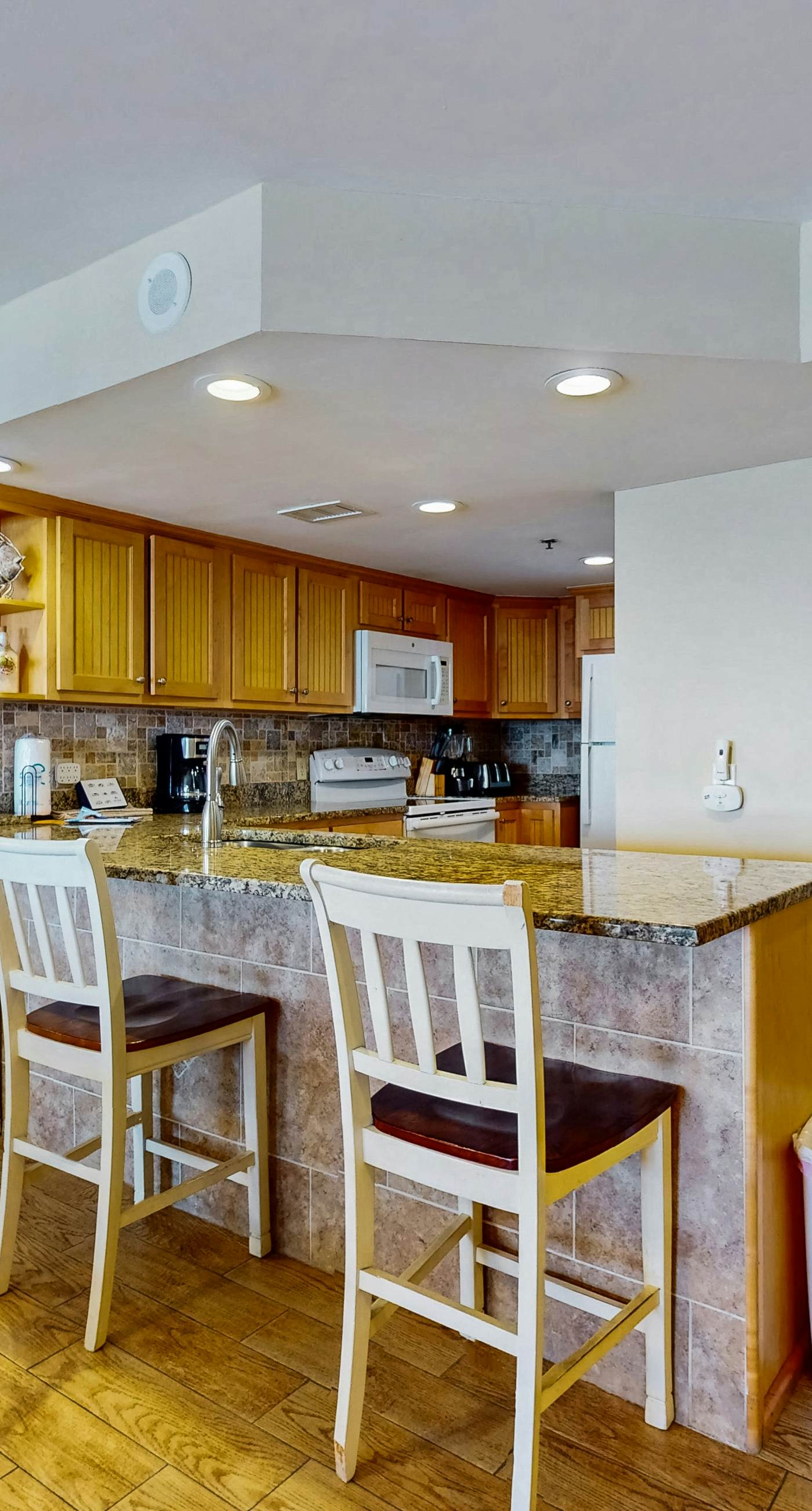 Waterfront condo w/ an open dining & living area, private balcony, shared pools