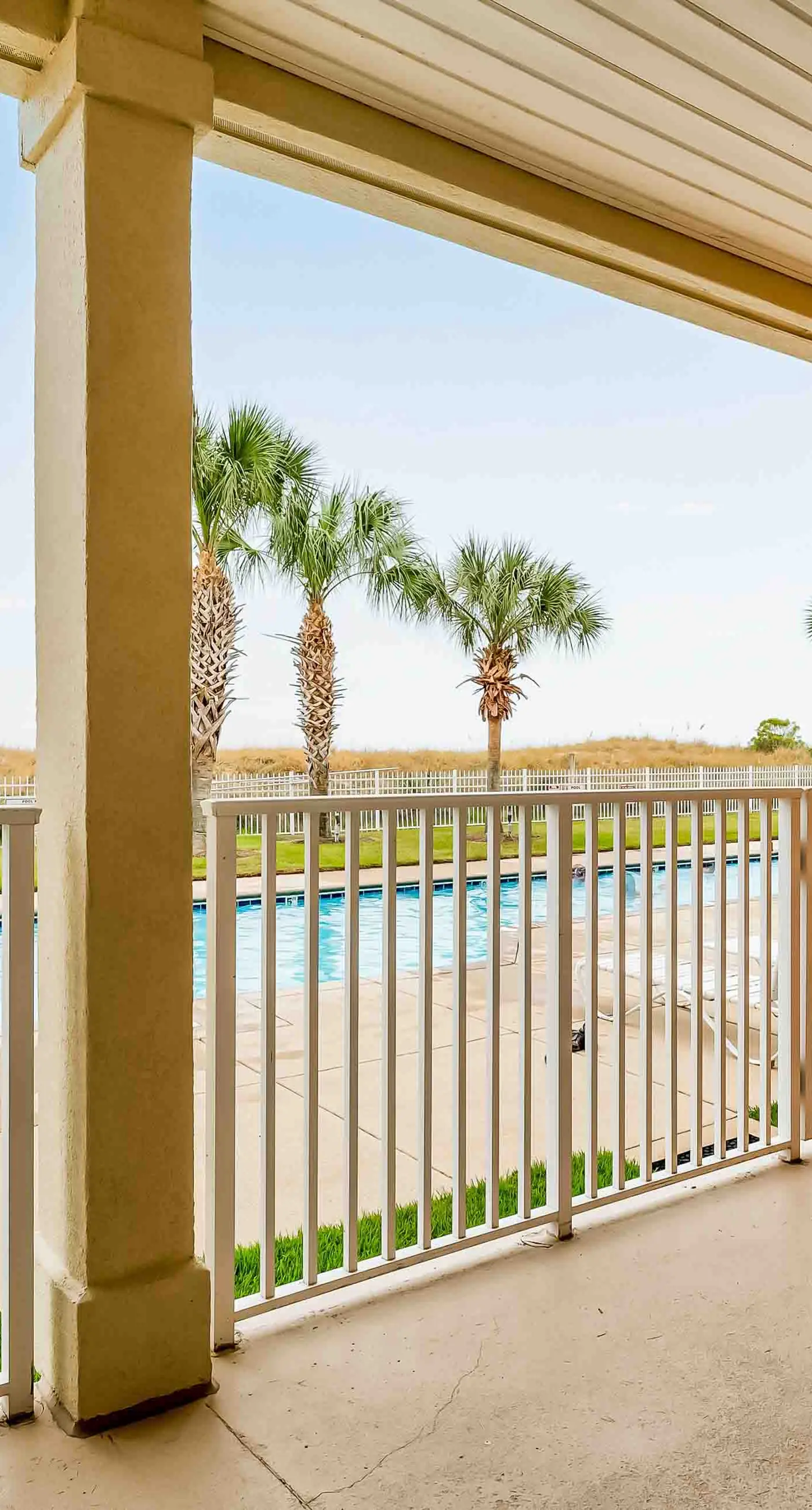 Ground-floor condo next to on-site pool with private patio & beach access