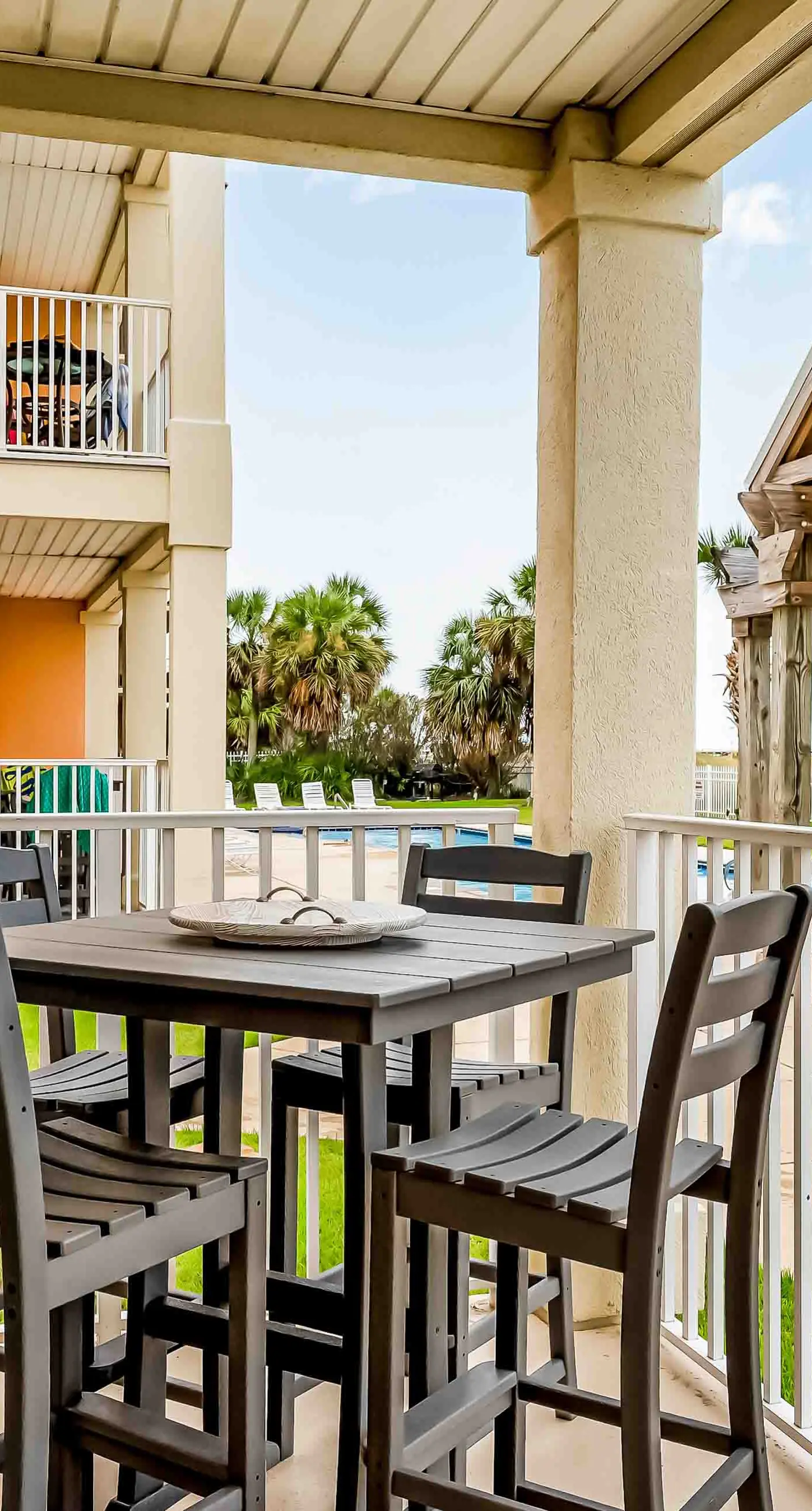Ground-floor condo next to on-site pool with private patio & beach access