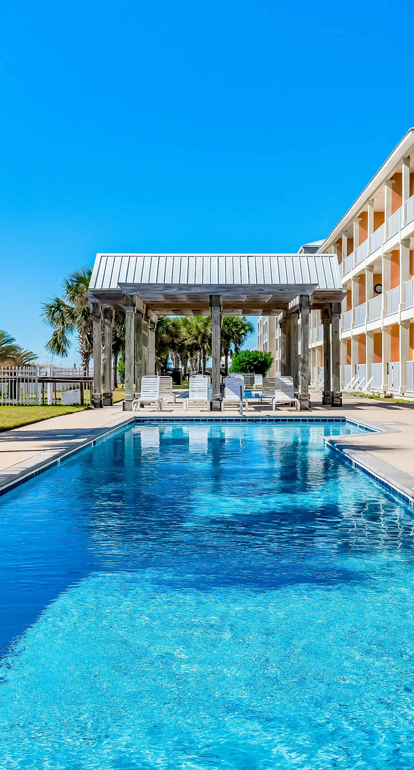 Ground-floor condo next to on-site pool with private patio & beach access