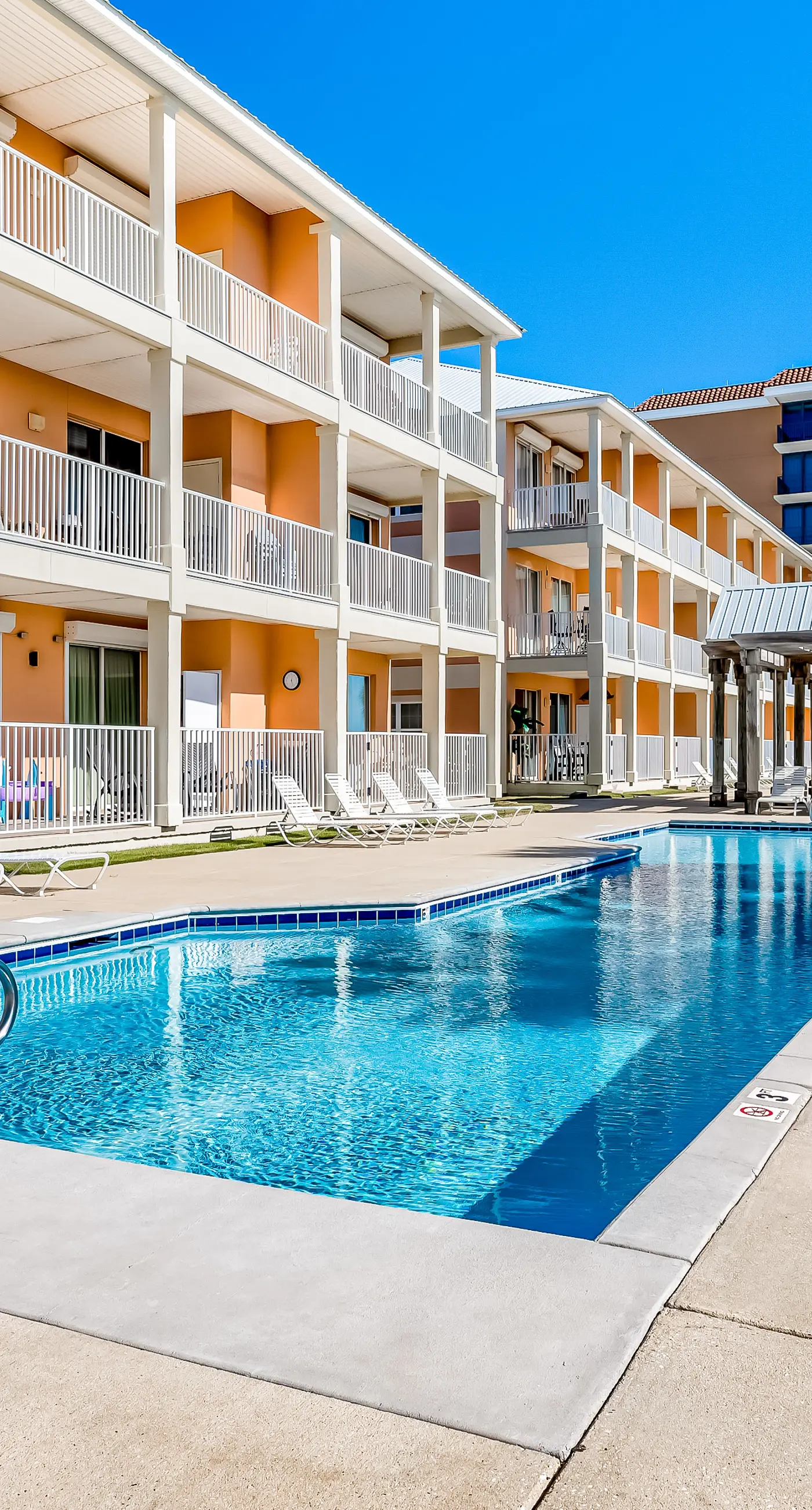 Ground-floor condo next to on-site pool with private patio & beach access