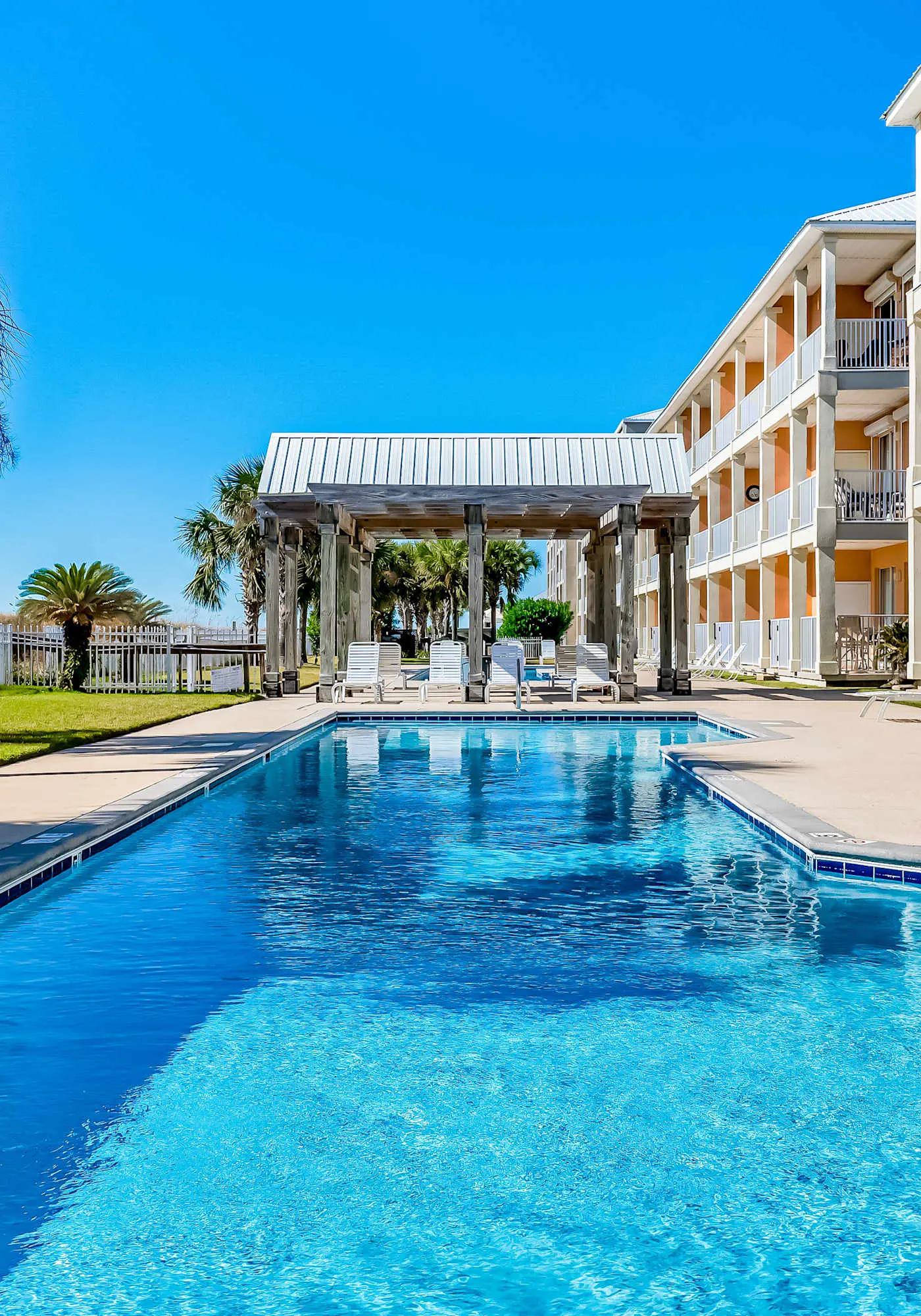 Ground-floor condo next to on-site pool with private patio & beach access
