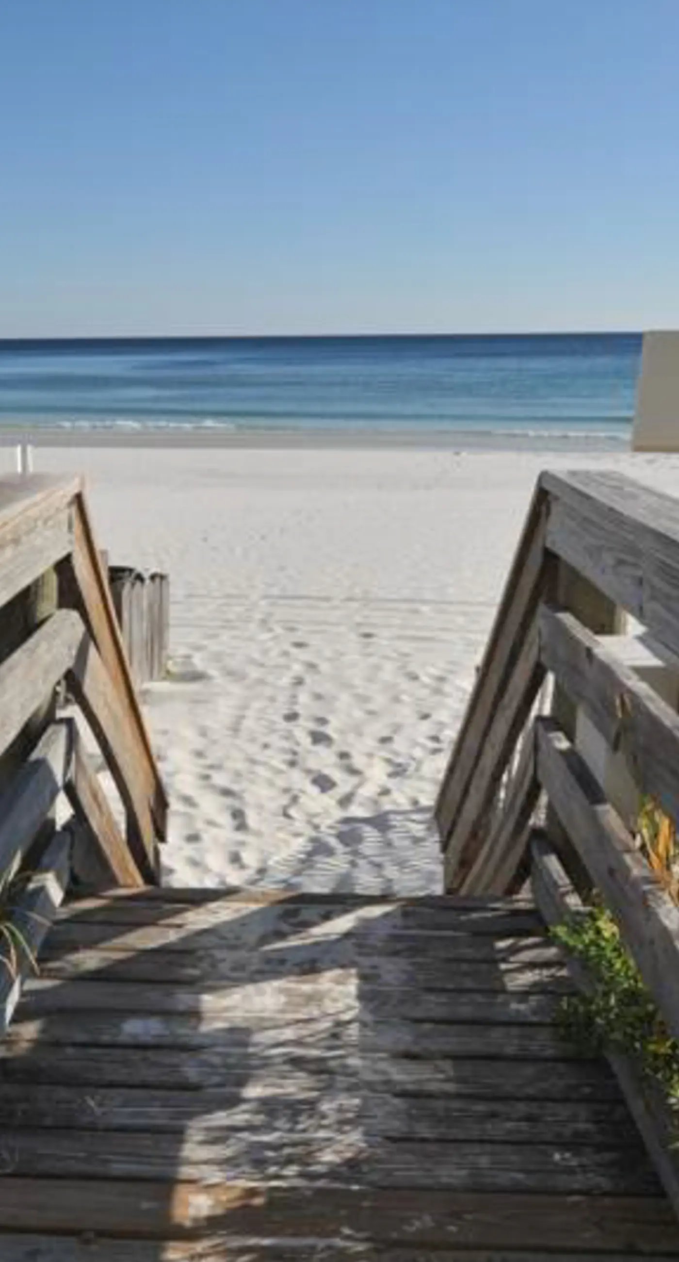 Waterfront escape with gulf views, pool, beach access, gym, balcony & AC