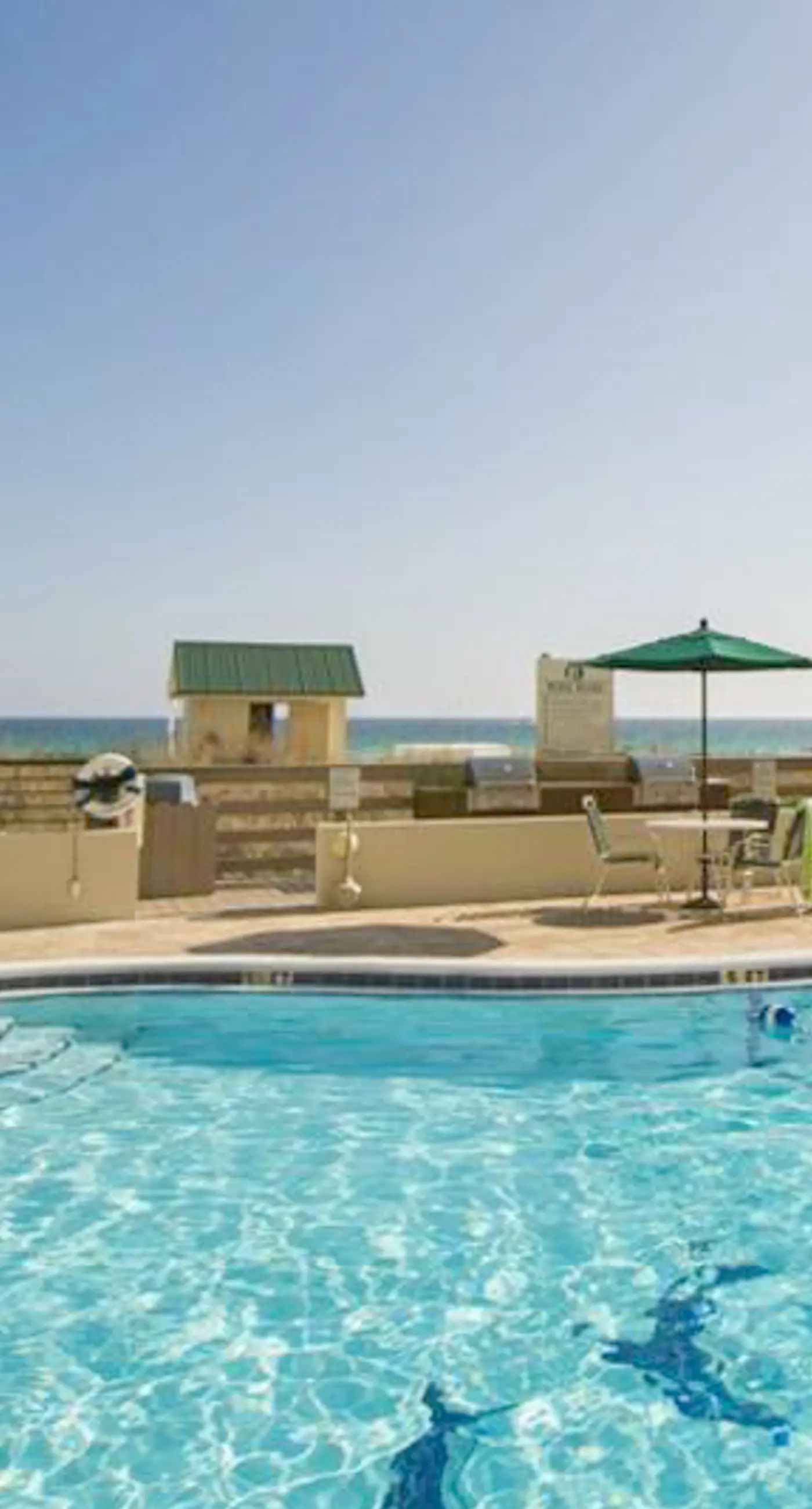 Waterfront escape with gulf views, pool, beach access, gym, balcony & AC