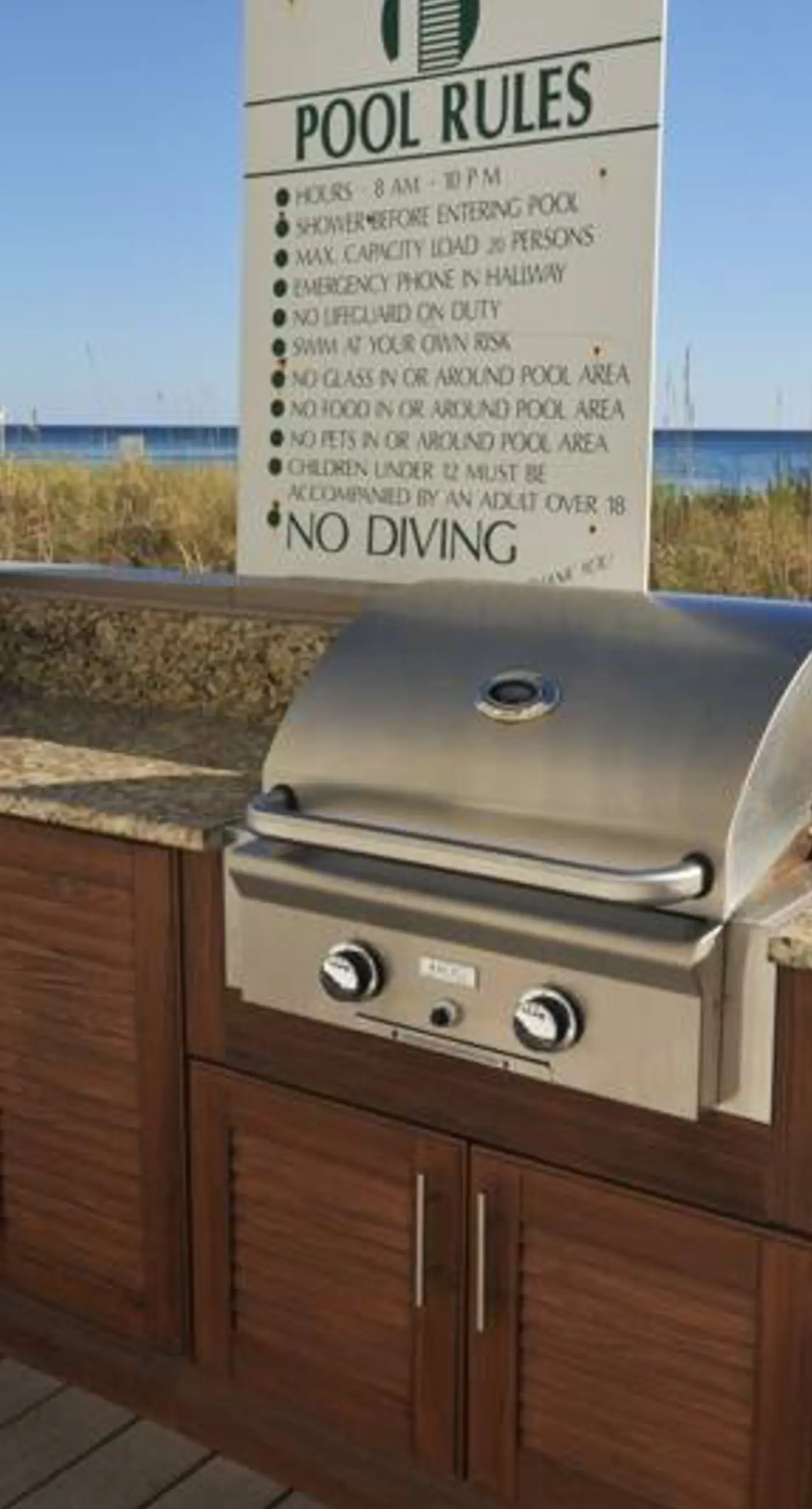 Waterfront escape with gulf views, pool, beach access, gym, balcony & AC