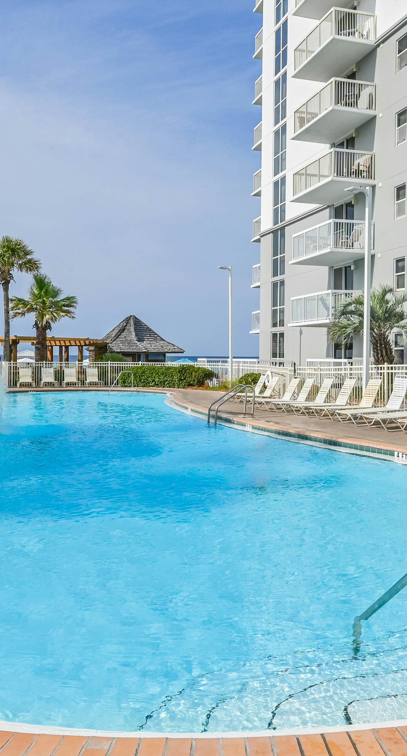 Gulf-front condo with balcony, water views, pools, hot tub & beach access