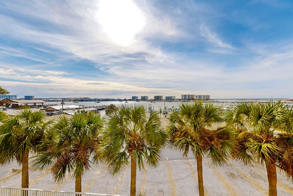 Dog-friendly waterfront & gated condo with pool access, balcony, AC, & W/D