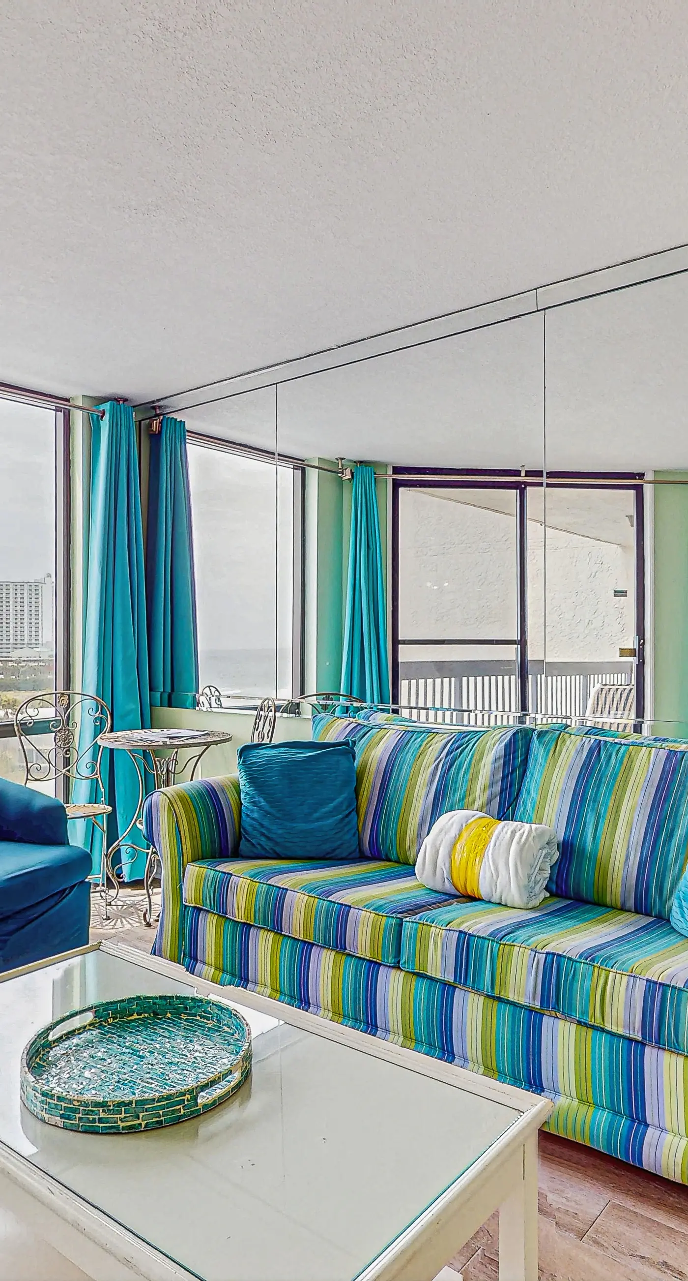 Colorful 6th-floor condo with partial gulf view, balcony, pool, hot tub, W/D, AC