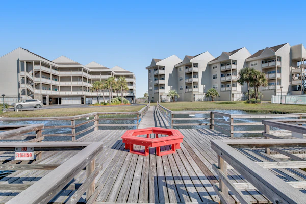 Condo with partial bay view, onsite fishing dock, beach access, & shared pool