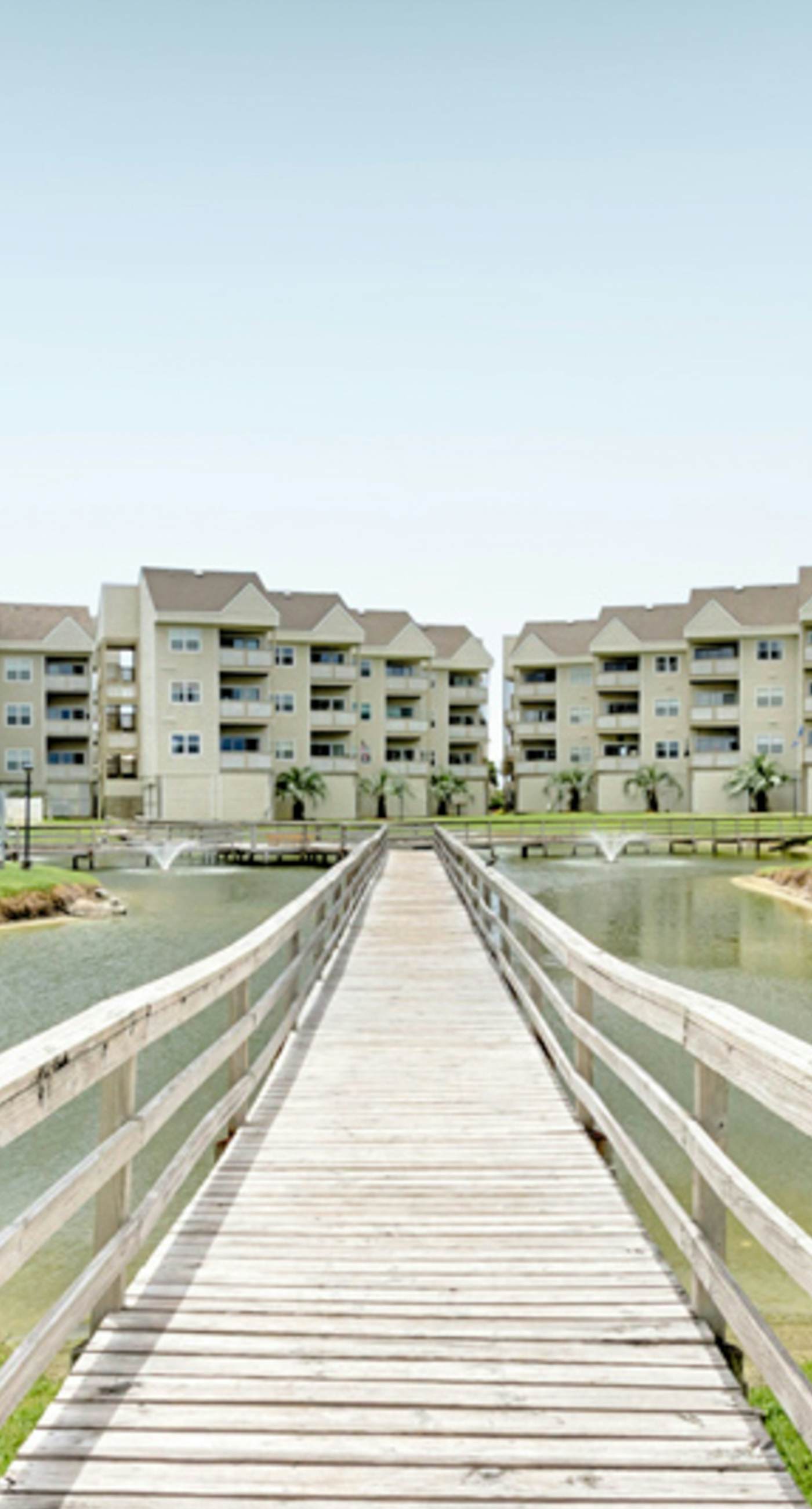 Condo with partial bay view, onsite fishing dock, beach access, & shared pool